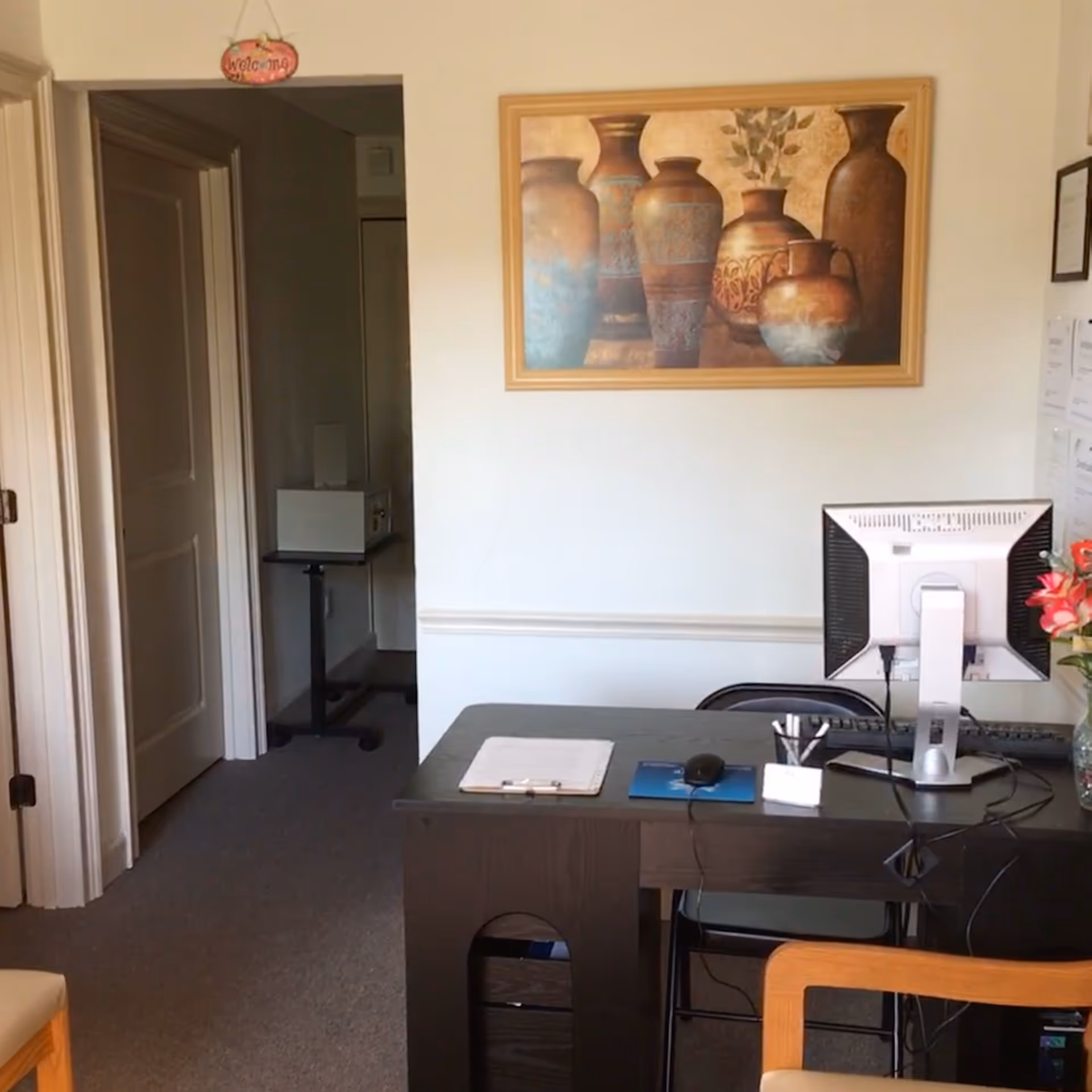 Desk with computer in a small office area of a senior care facility.