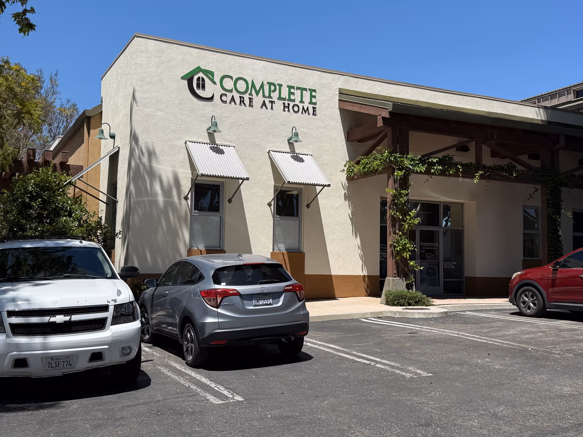 Exterior of Complete Care at Home facility with parked cars and entrance sign
