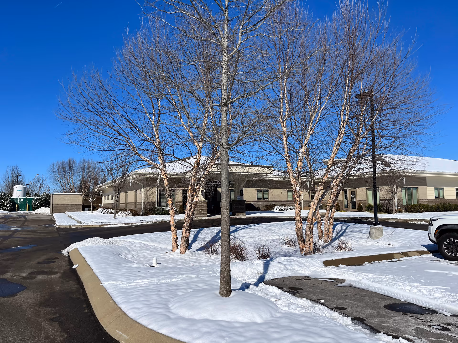 Winter exterior view of Alive Hospice Murfreesboro building with snow.