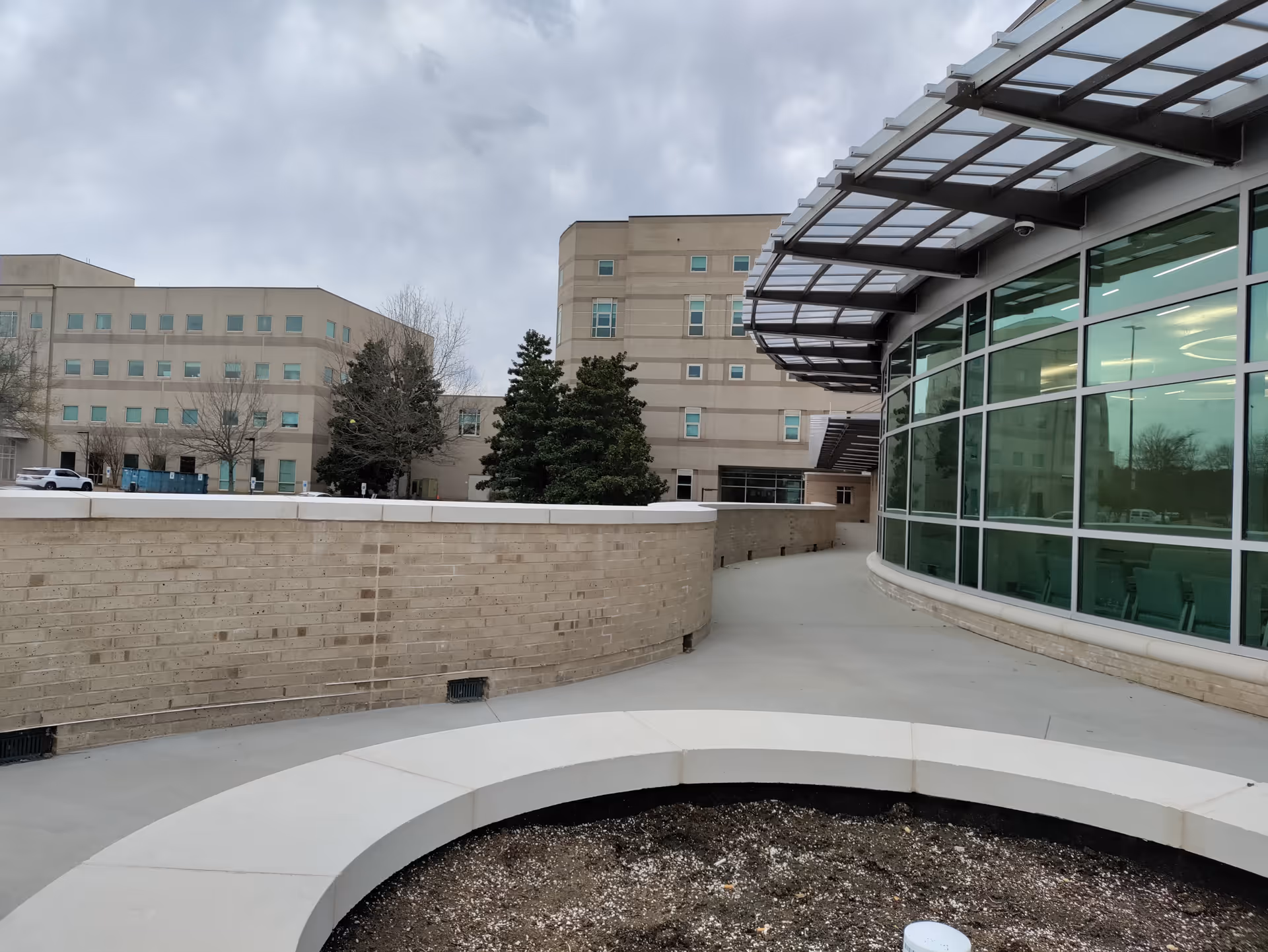 Outside view of Cullman Regional Medical Center showing curved glass entrance and brick walls.