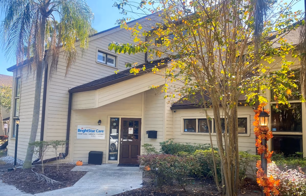 Exterior view of BrightStar Care building entrance with sign and landscaping.