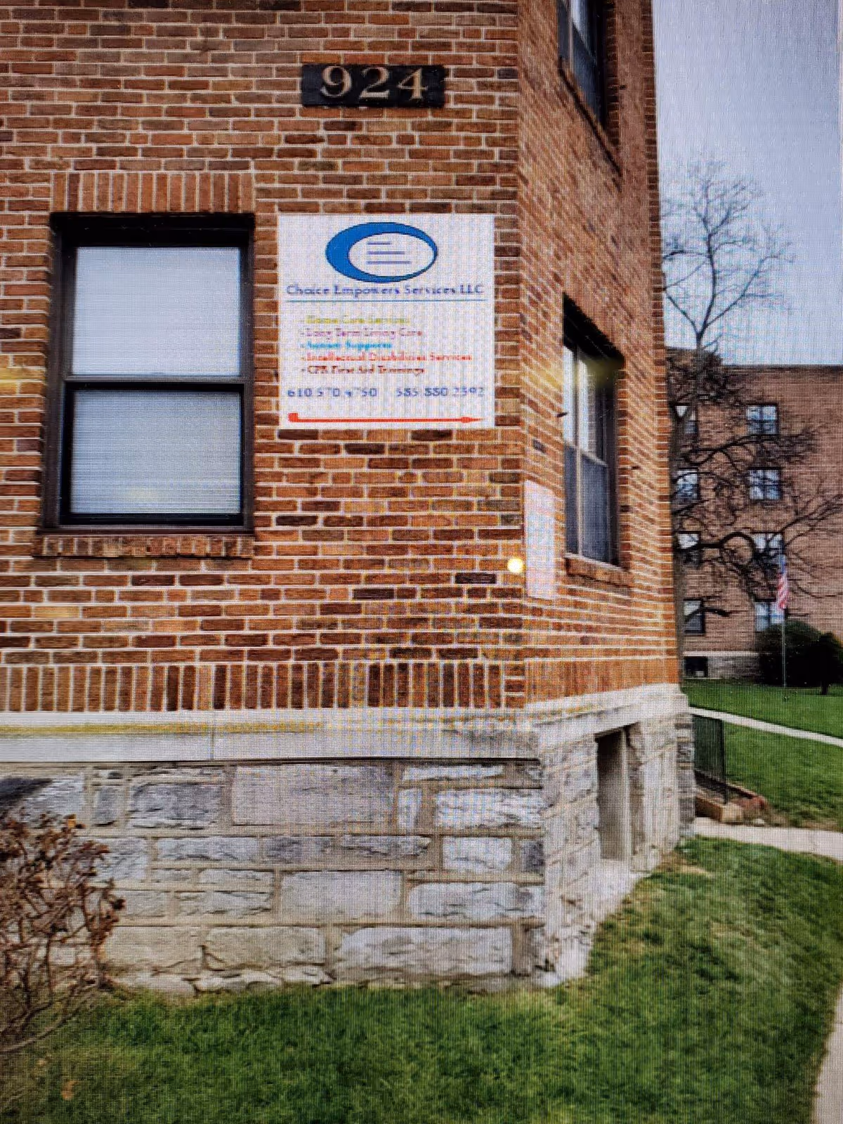 Brick building exterior with Choice Empowers Services LLC sign and surrounding landscaping.