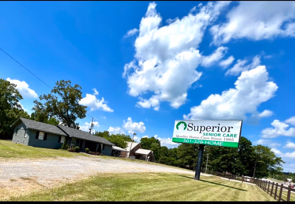 Exterior view of Superior Senior Care facility with a large sign and blue sky