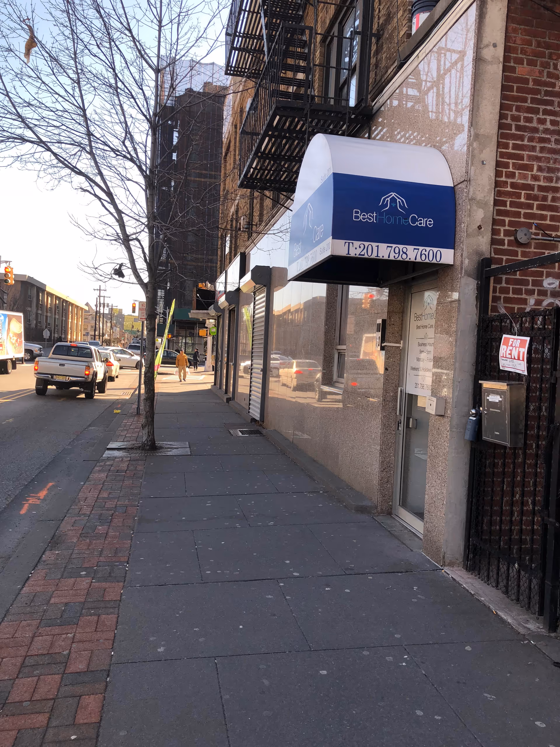 City sidewalk storefront with Best Home Care awning and building exterior