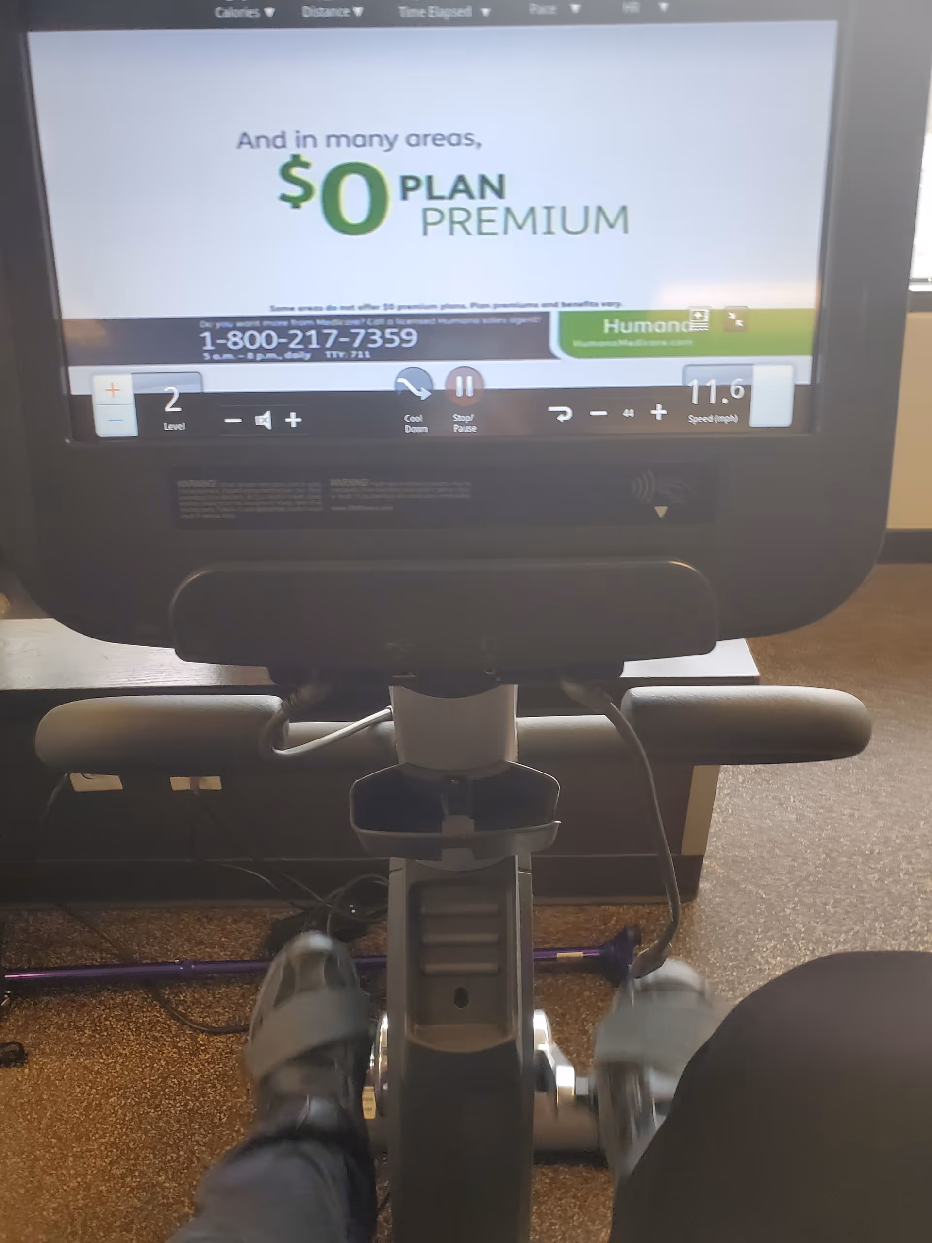 Indoor gym area featuring a stationary bike and a large screen.