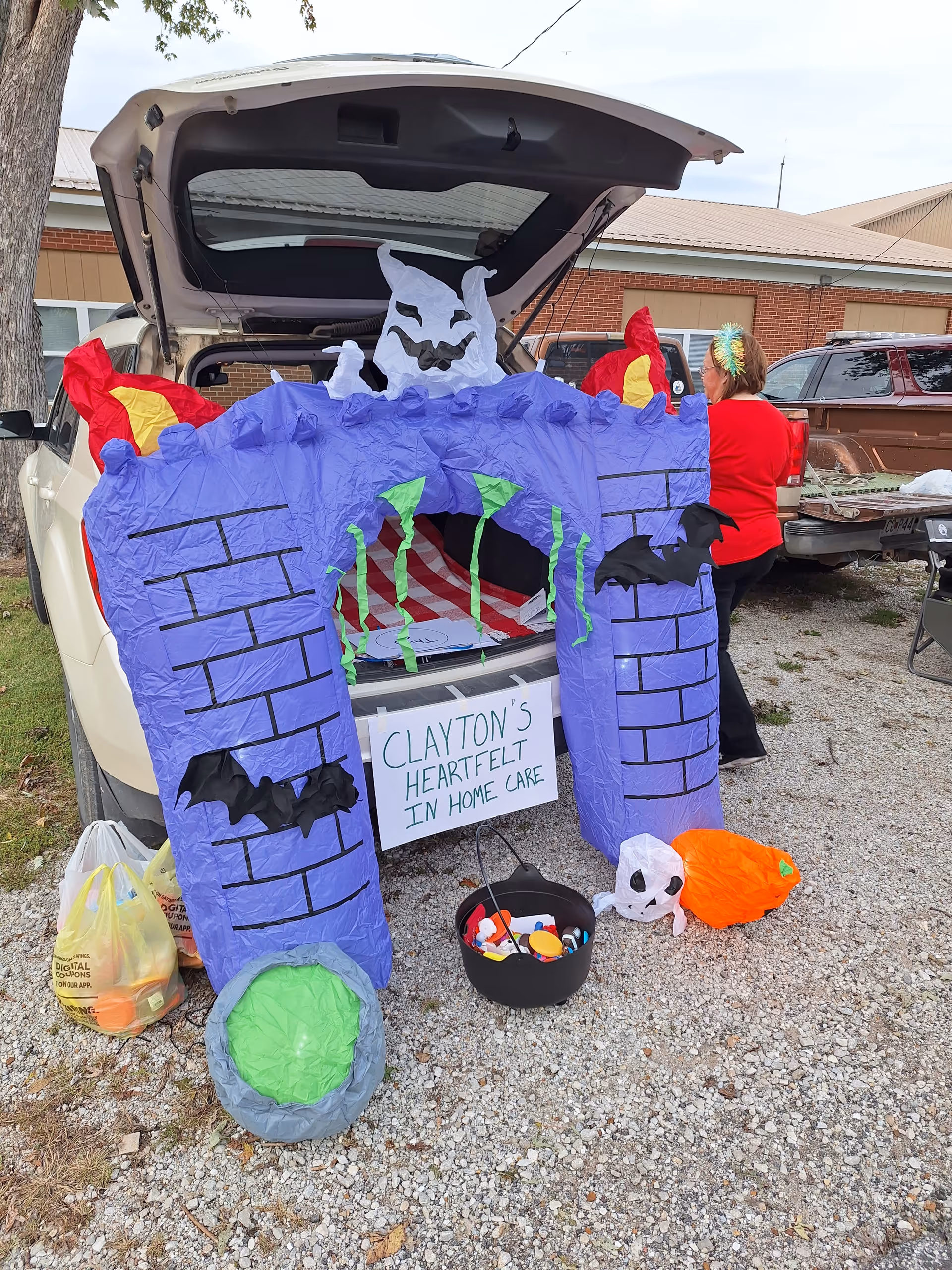 Purple castle Halloween display extends from an open car trunk at Clayton's Heartfelt in Home Care.
