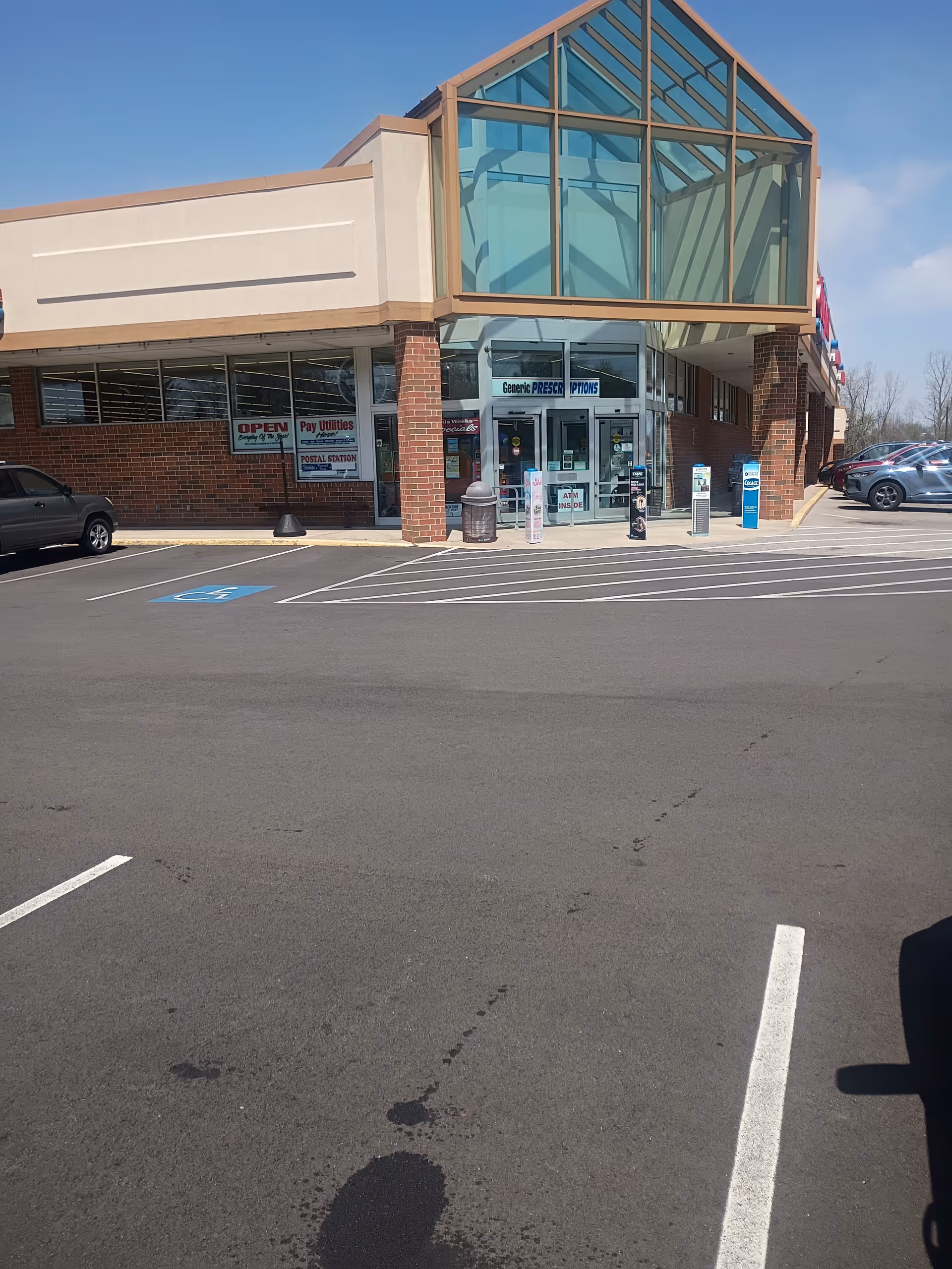 Discount Drug Mart storefront with a glass entrance and a parking lot.