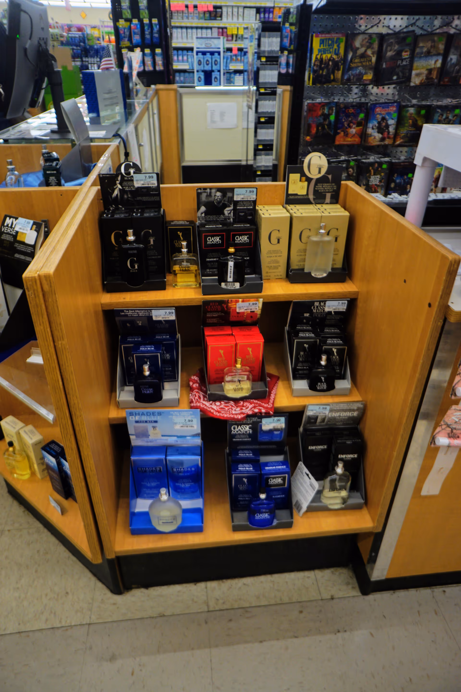 Wooden display shelf full of perfume boxes inside Discount Drug Mart store.