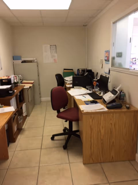 Office area with desks, chairs, and computers inside St. Francis Community Care.
