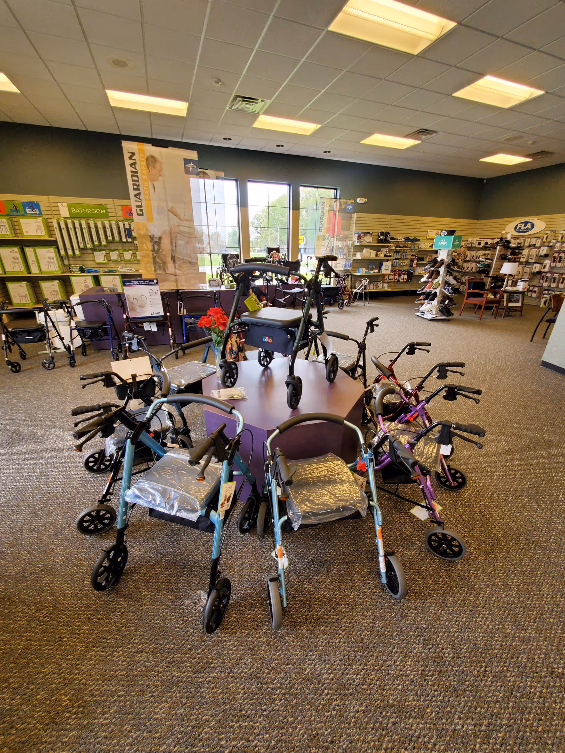 Indoor showroom at Alick's Home Medical displaying walkers and wheelchairs.