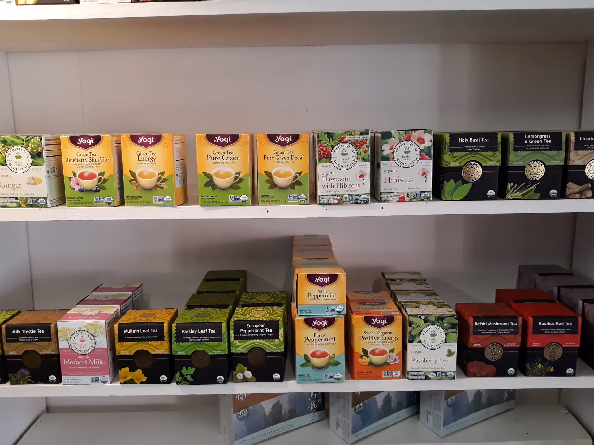 Shelves lined with assorted tea boxes in a tidy indoor display.