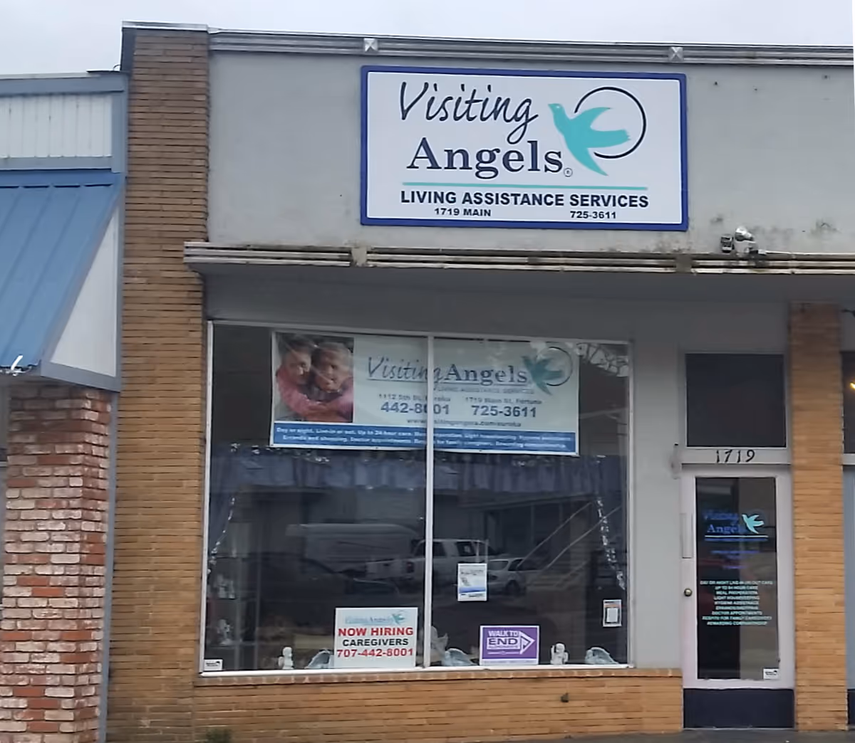 Exterior storefront of Visiting Angels with large sign and front window display.