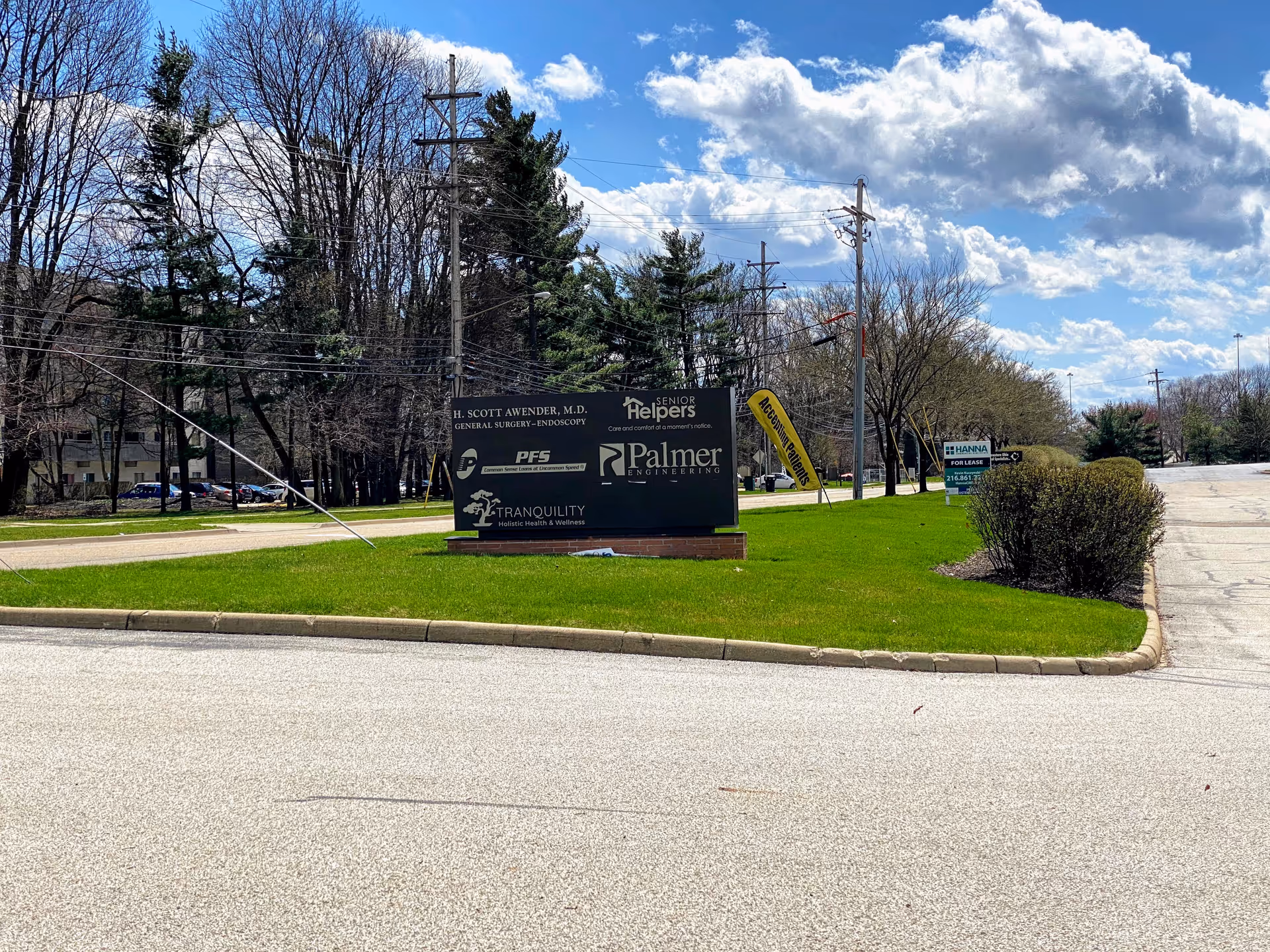Exterior Senior Helpers sign on a grassy median by the street.