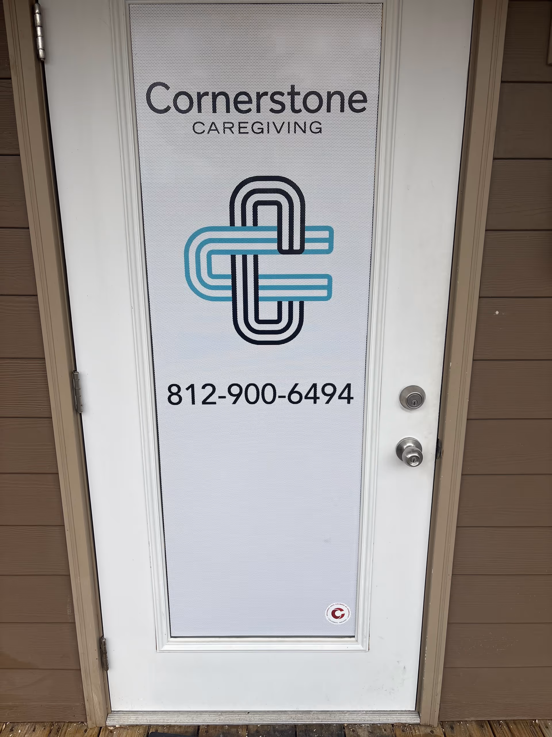 Exterior front door displays Cornerstone Caregiving logo and phone number.