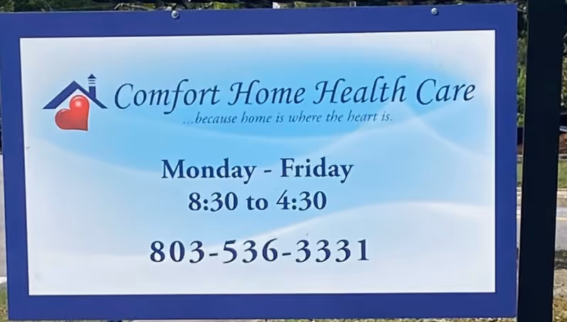 Outdoor sign reads Comfort Home Health Care with hours Monday-Friday 8:30-4:30 and phone 803-536-3331