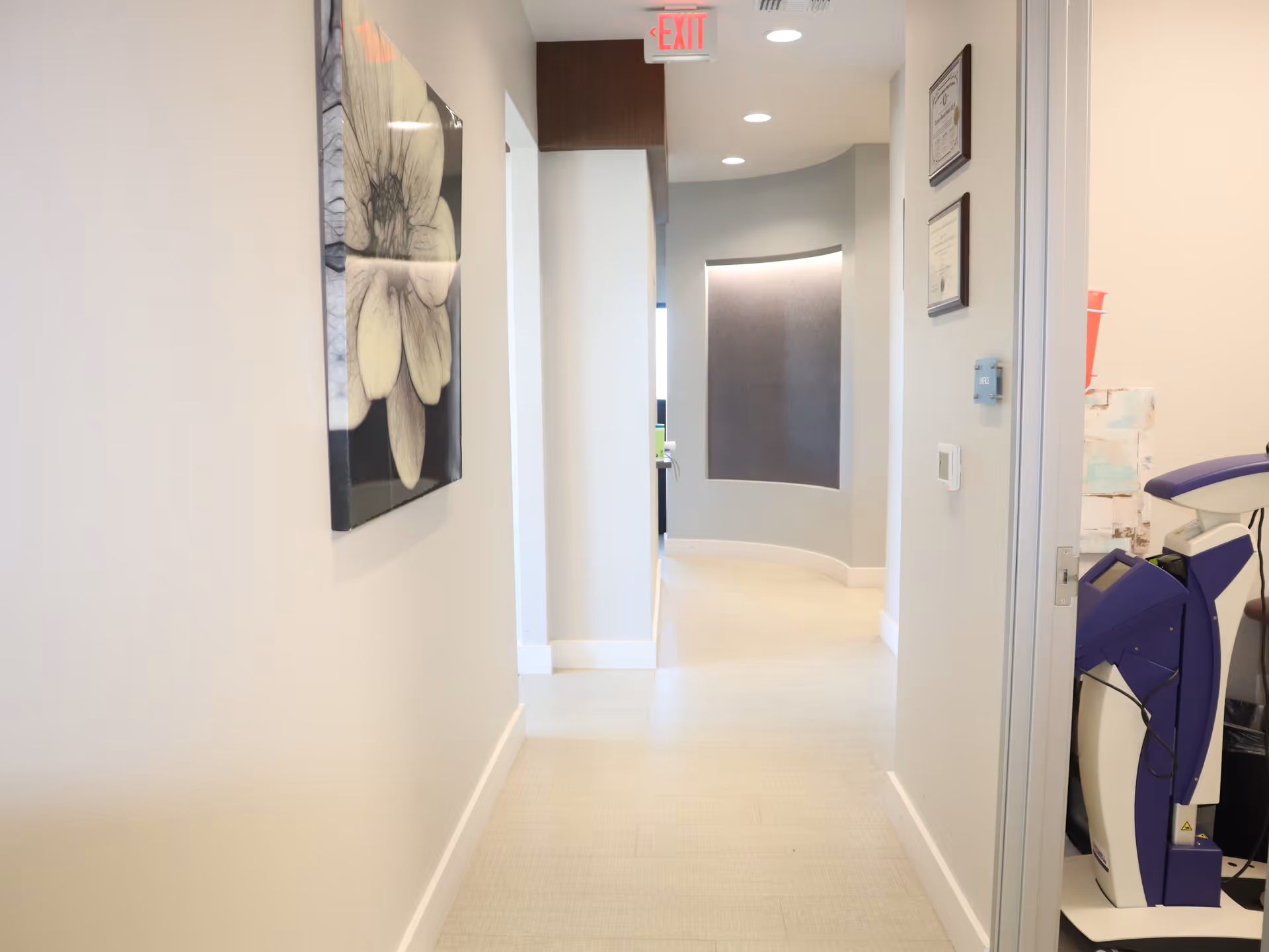 Bright hallway in a senior living facility with medical equipment along the wall.