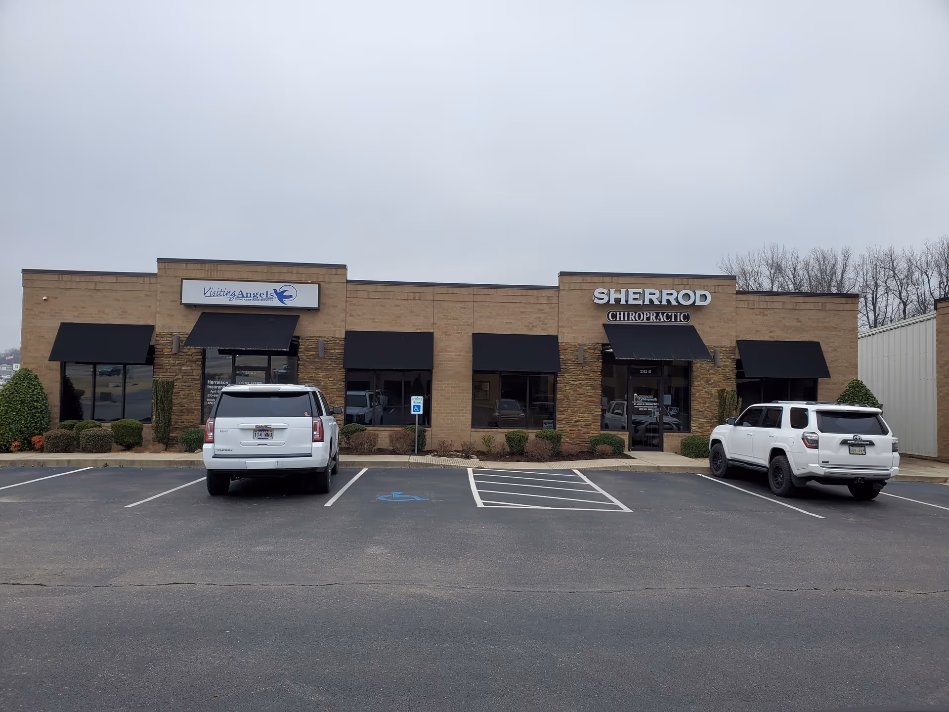 A strip mall storefront featuring Visiting Angels Senior Home Care and a chiropractic clinic.