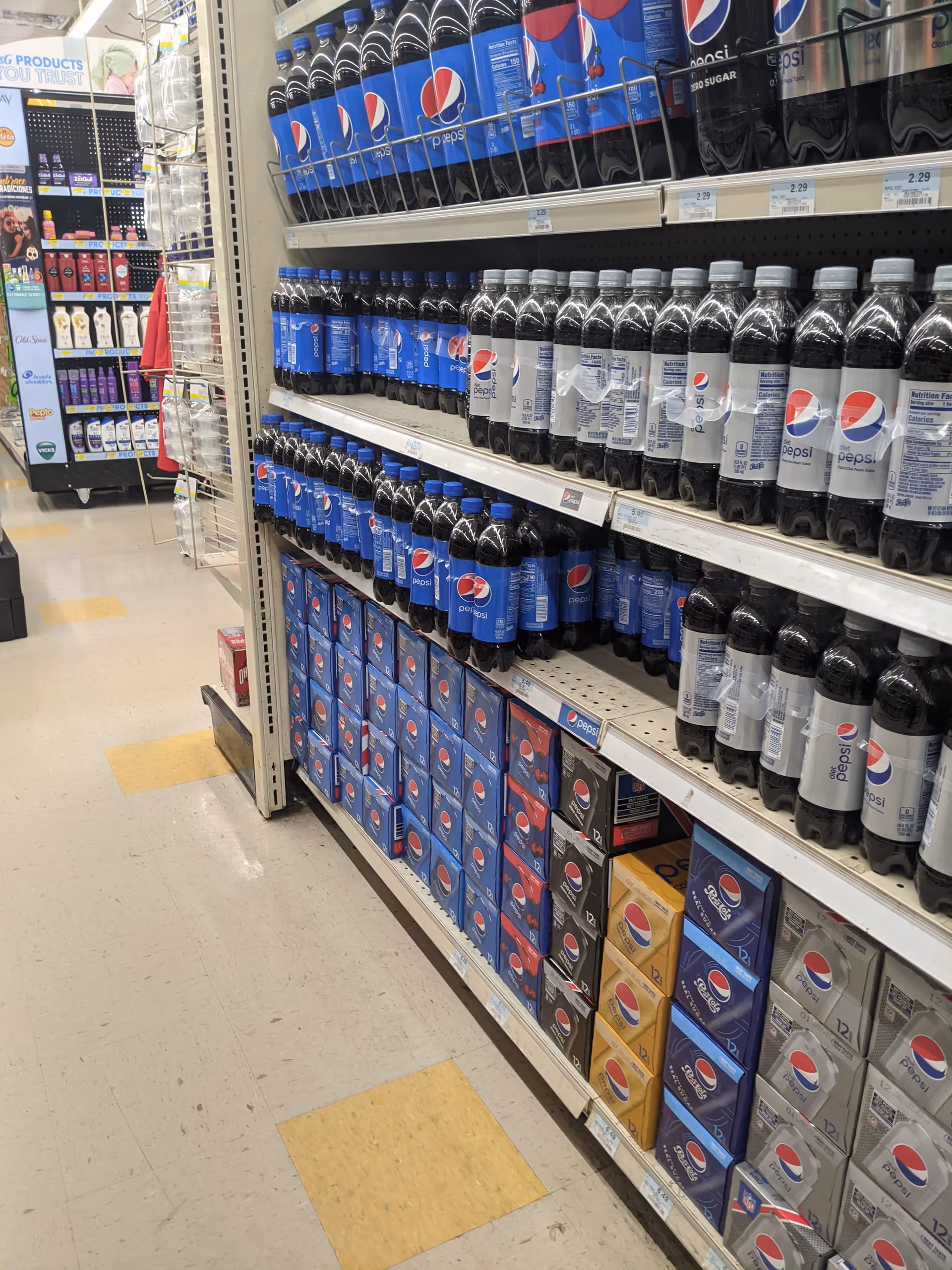 Aisle of beverage shelves in Discount Drug Mart store.