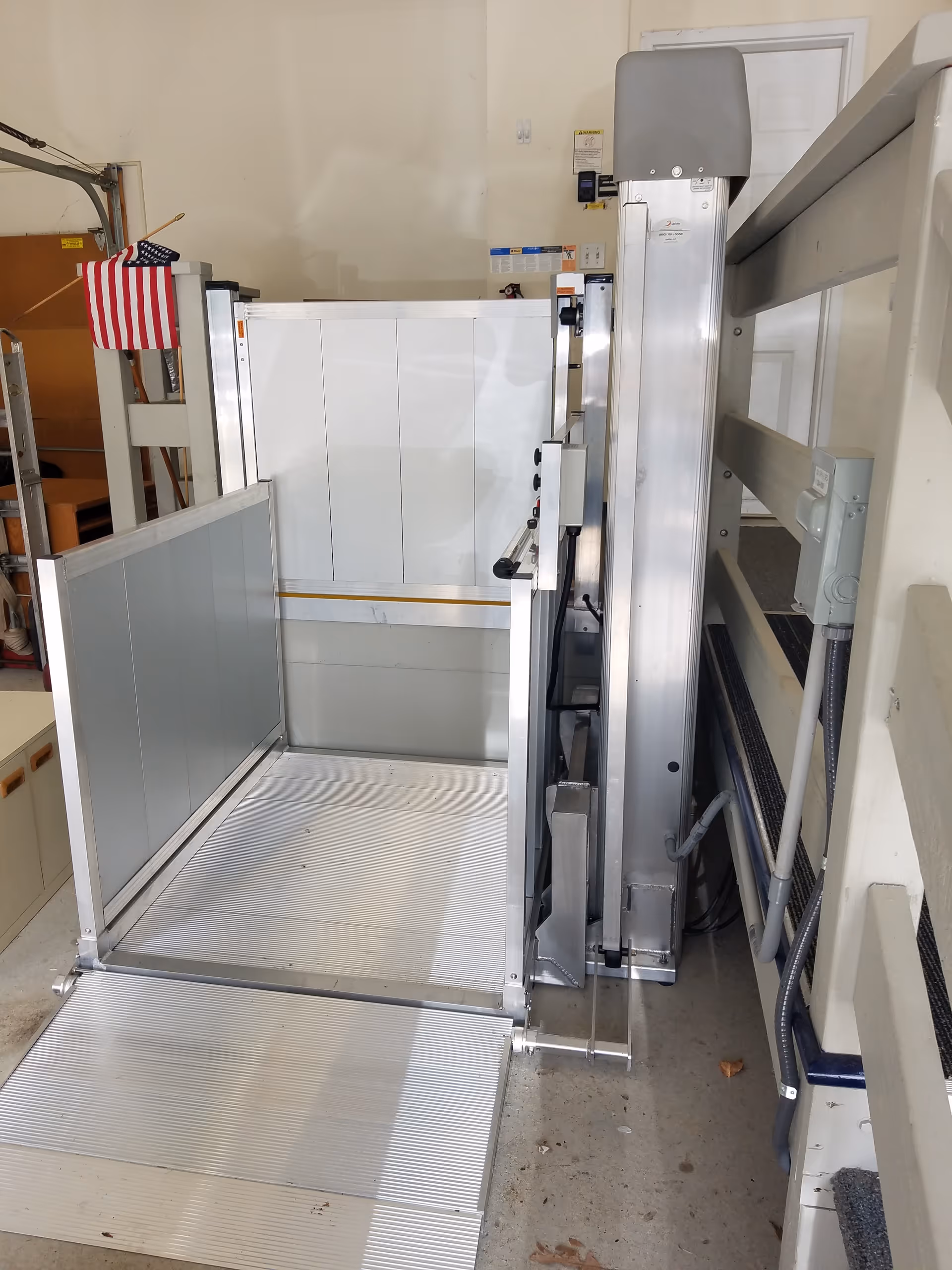 Indoor UpLifts platform lift with rails inside a senior living facility.