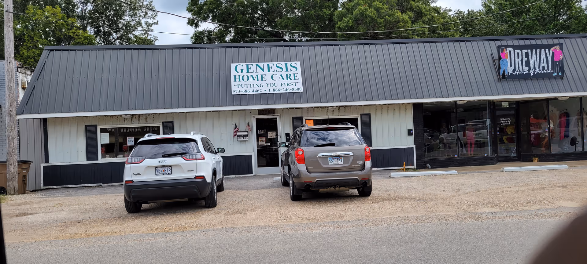 Exterior view of Genesis Home Care storefront with two parked cars in front of the building.