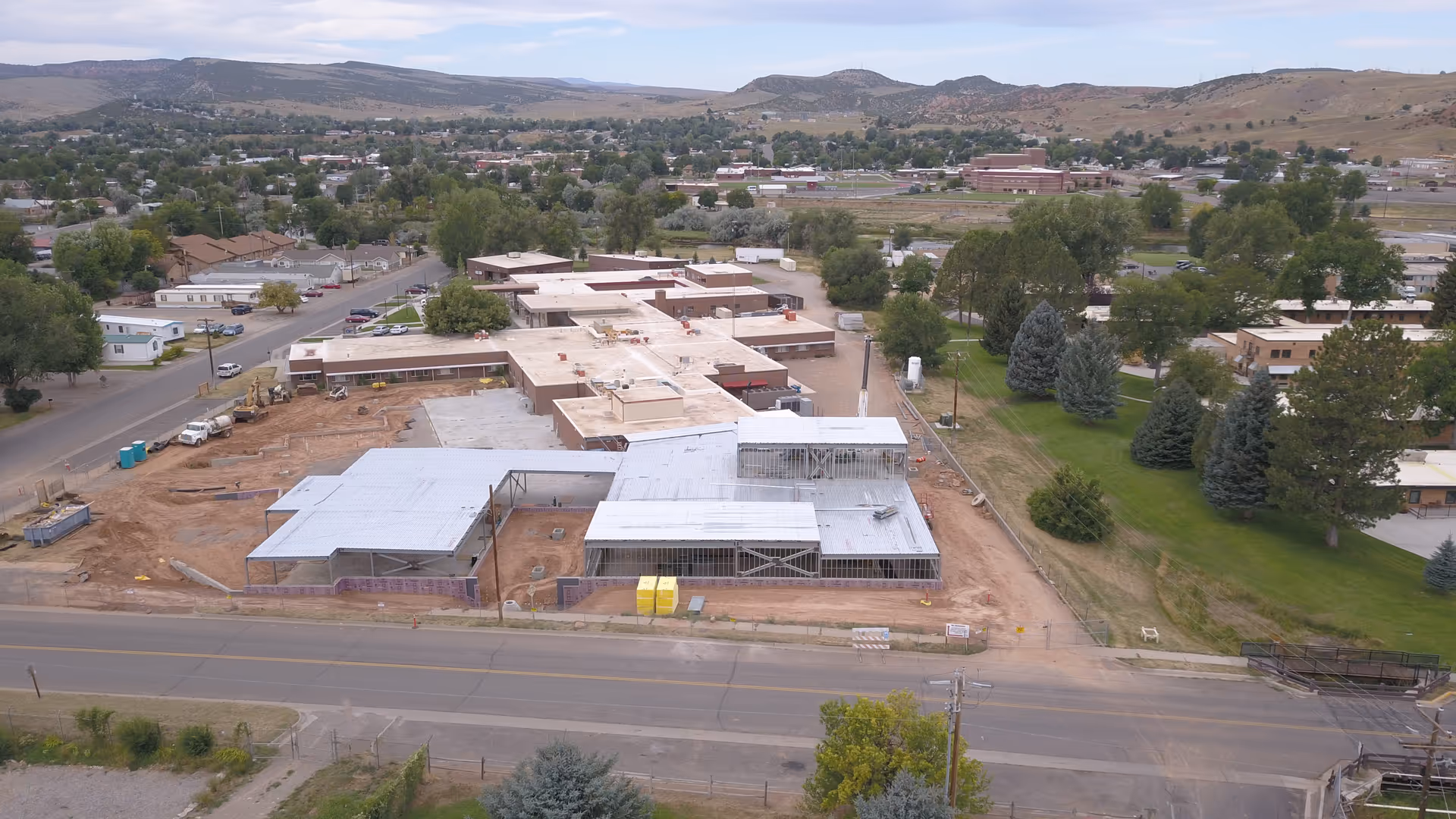 Aerial view of a senior living facility under construction with surrounding neighborhood