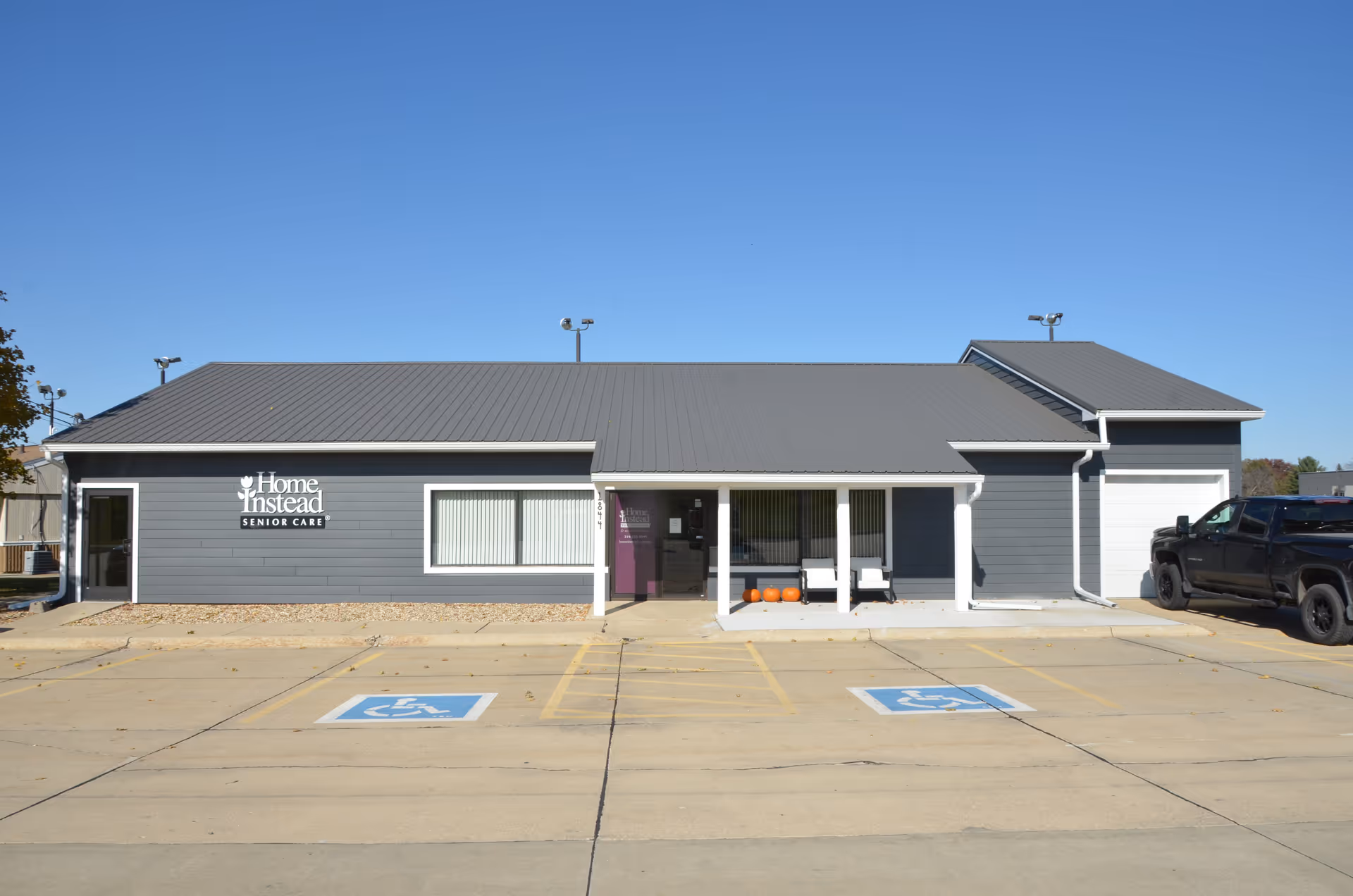 Exterior view of Home Instead Senior Care building with wheelchair-accessible parking.