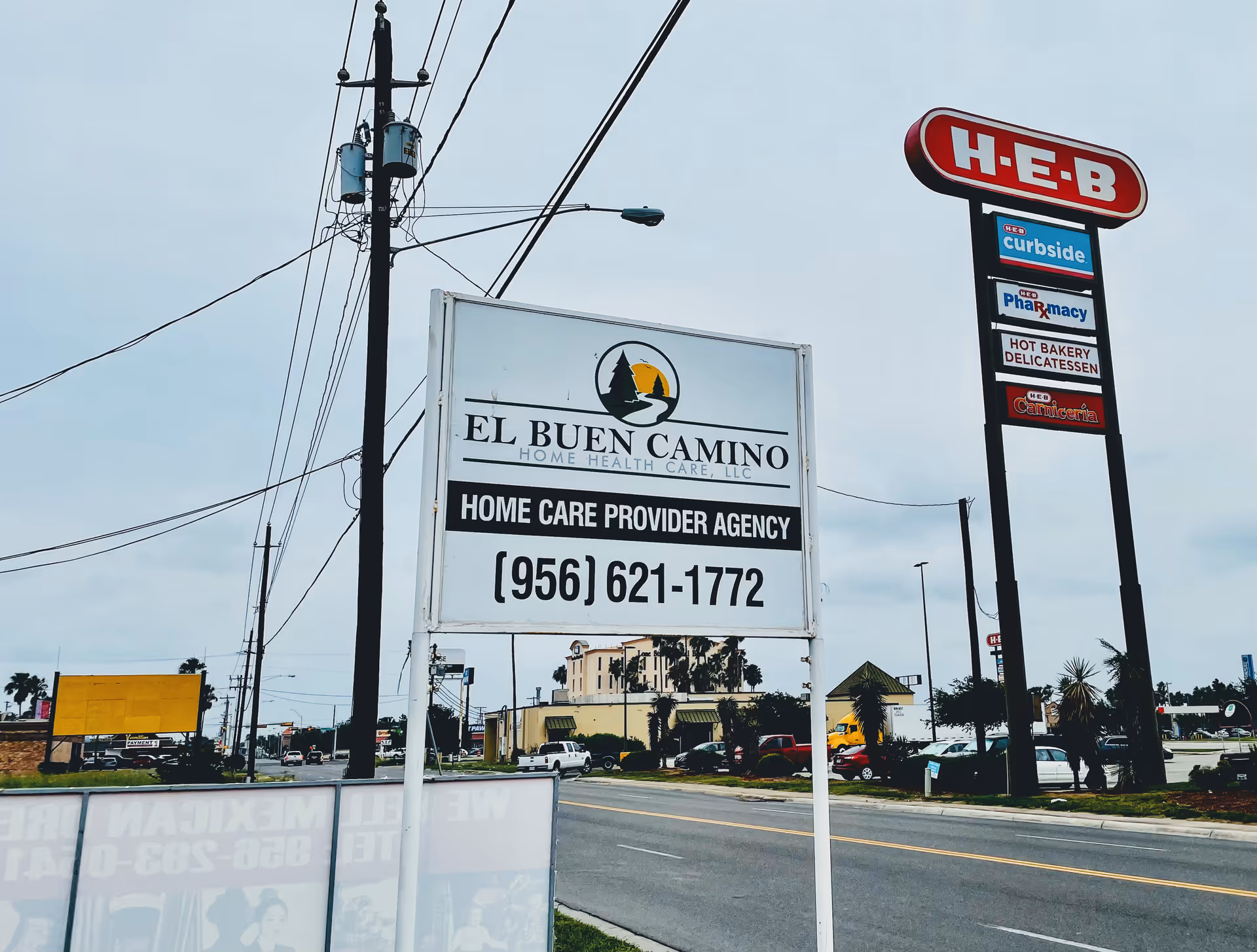 Roadside sign for El Buen Camino Home Health Care beside an H-E-B sign.