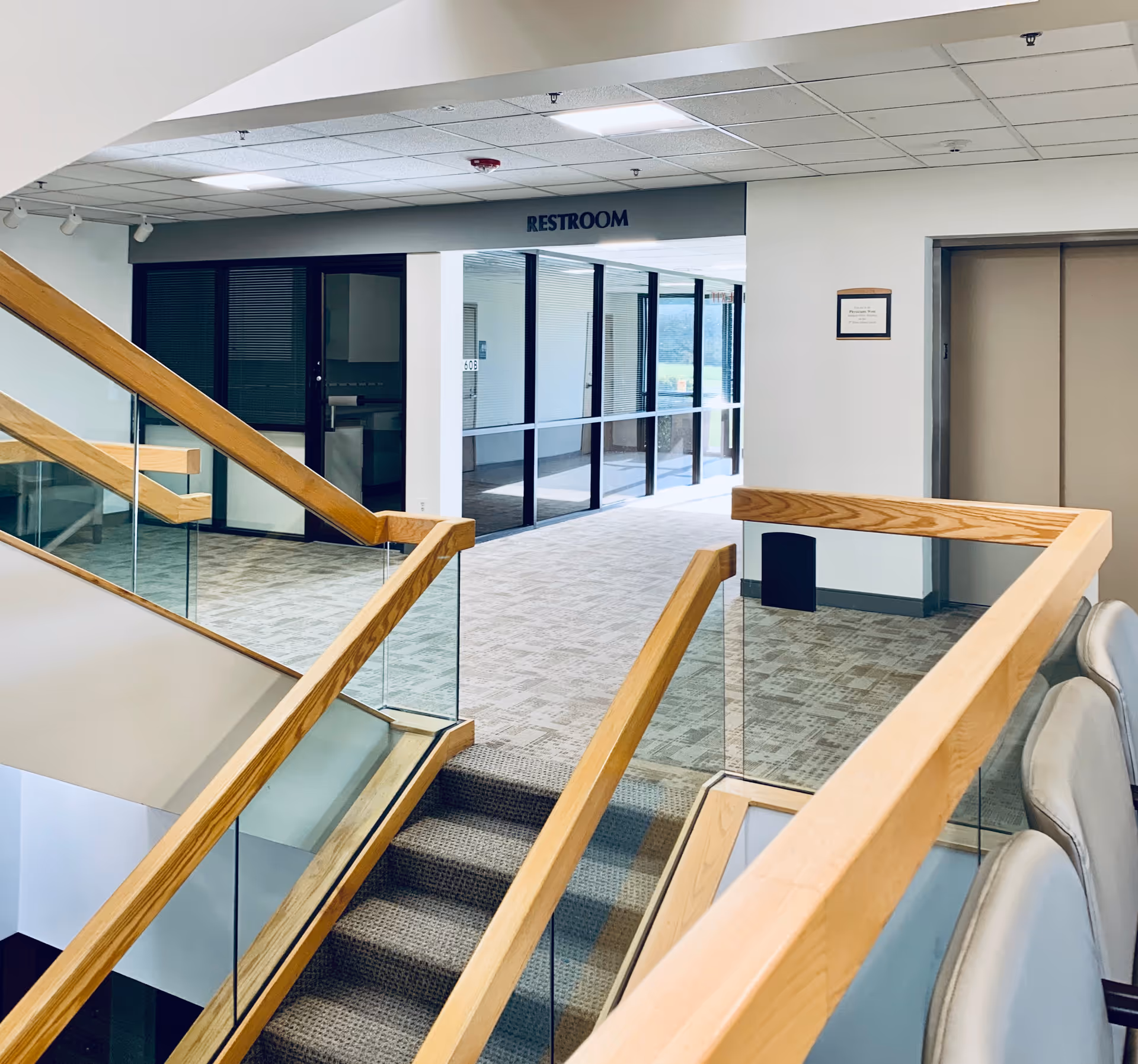 Interior view of a Crescent Regional Hospital corridor with glass doors and a restroom sign.