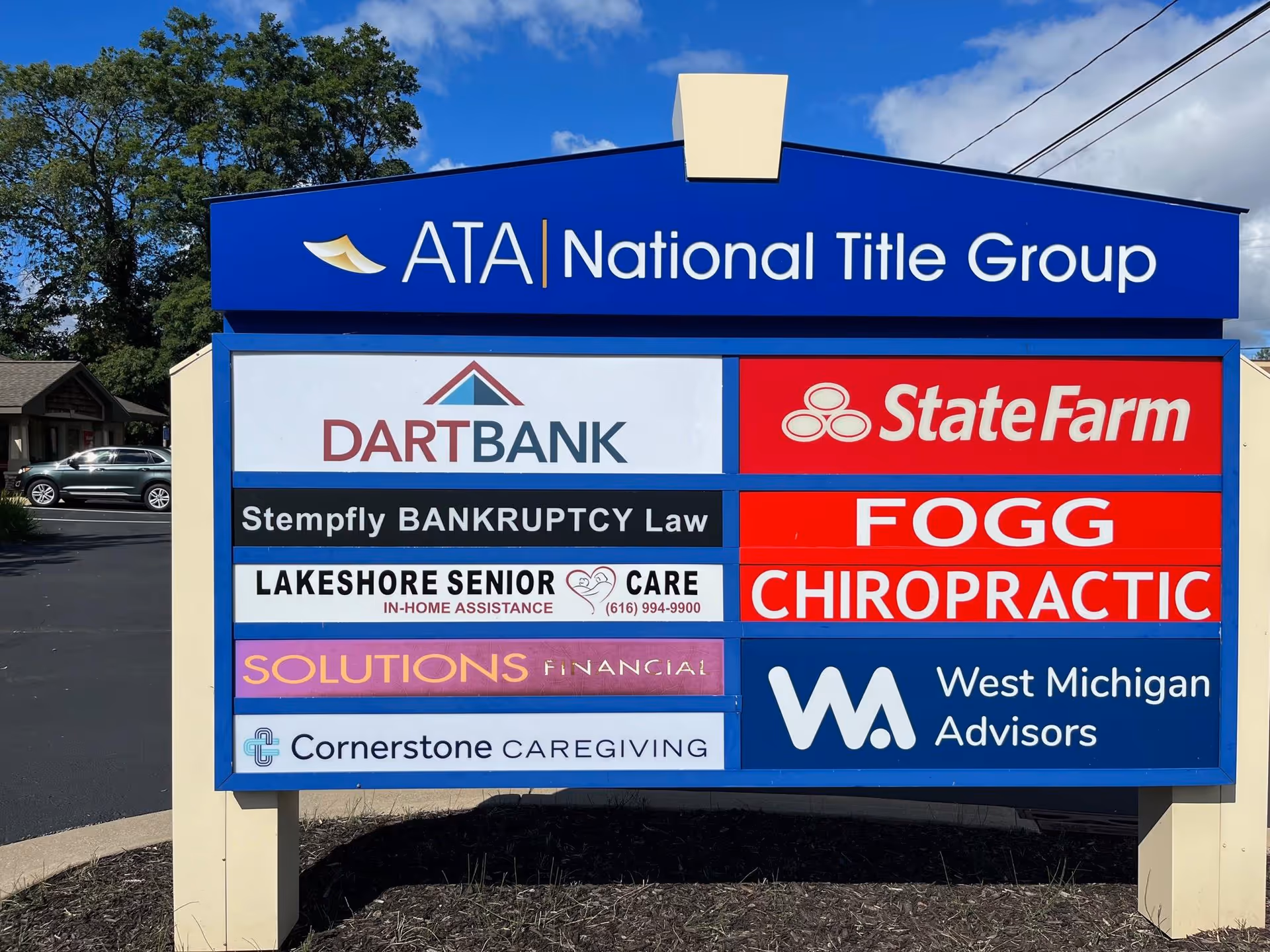 Outdoor signboard displaying multiple business logos, including Cornerstone Caregiving.