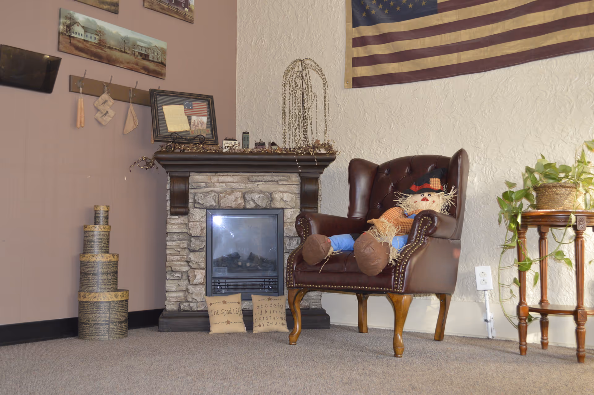 Cozy living room corner with a stone fireplace and leather armchair.