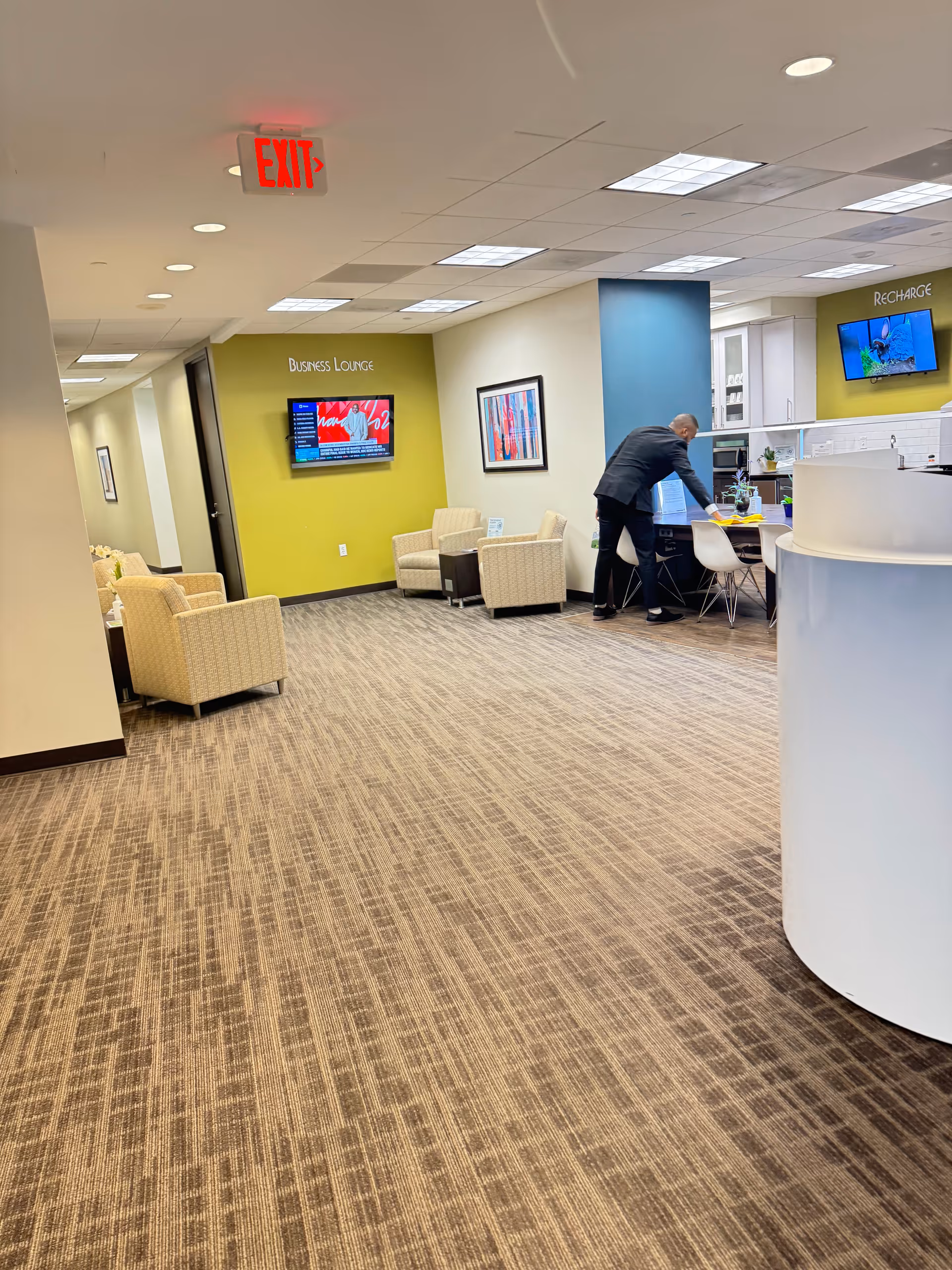 Bright interior lobby of a senior living facility with seating and reception desk.