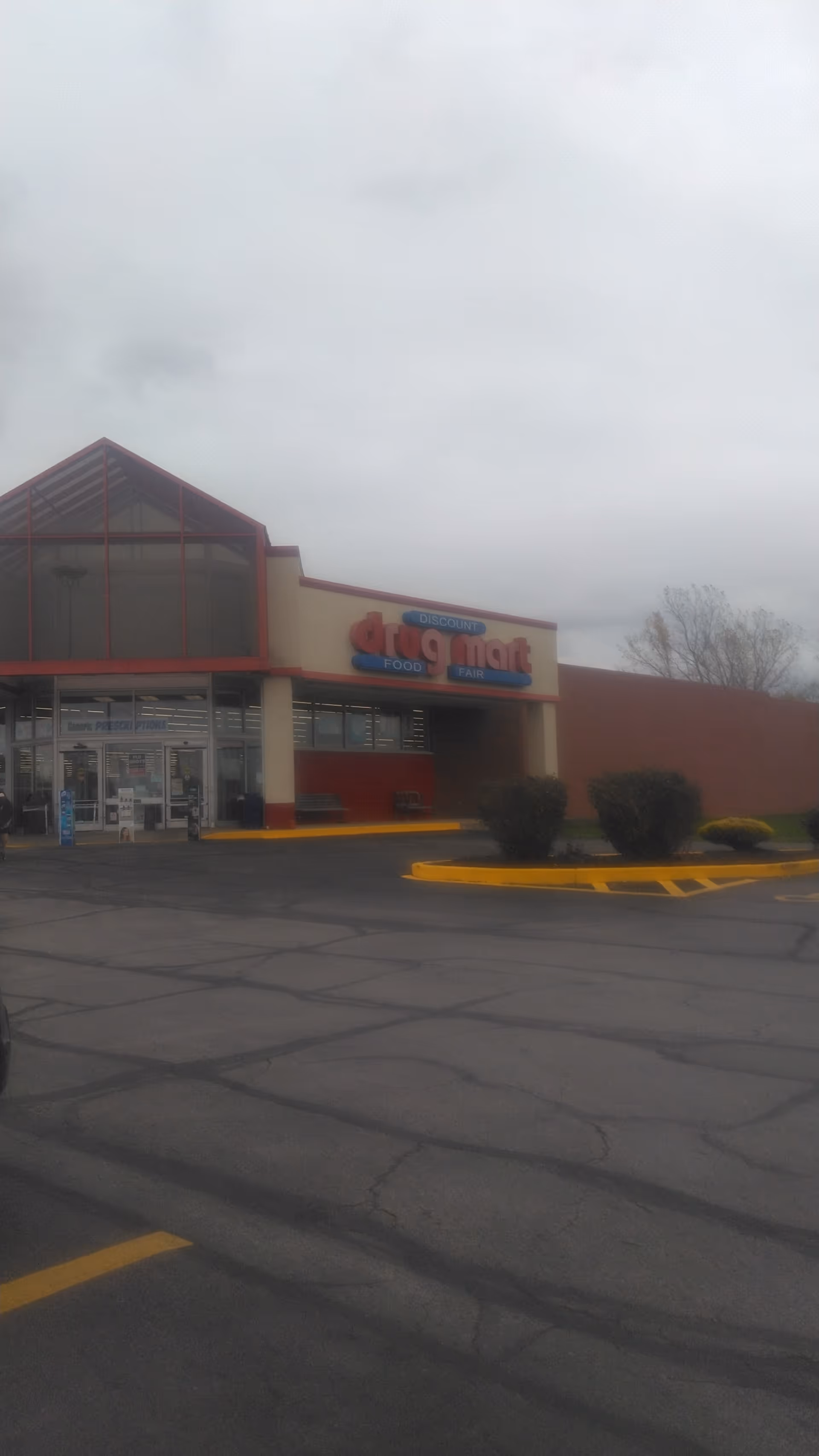 Exterior view of Discount Drug Mart storefront in a parking lot.
