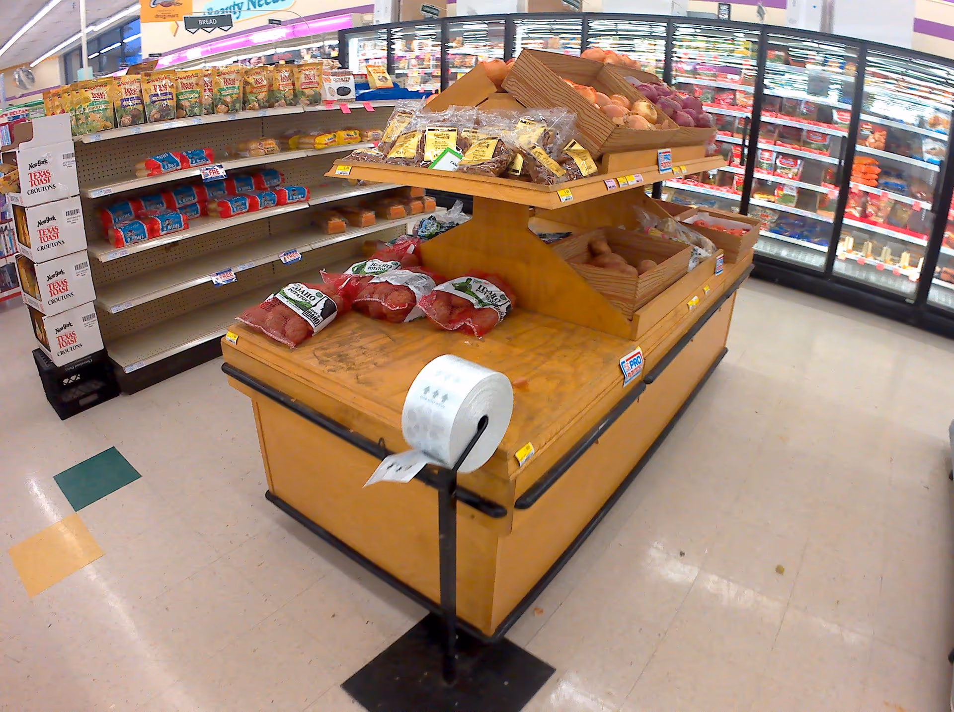 Central grocery display with meats and produce in a Discount Drug Mart store