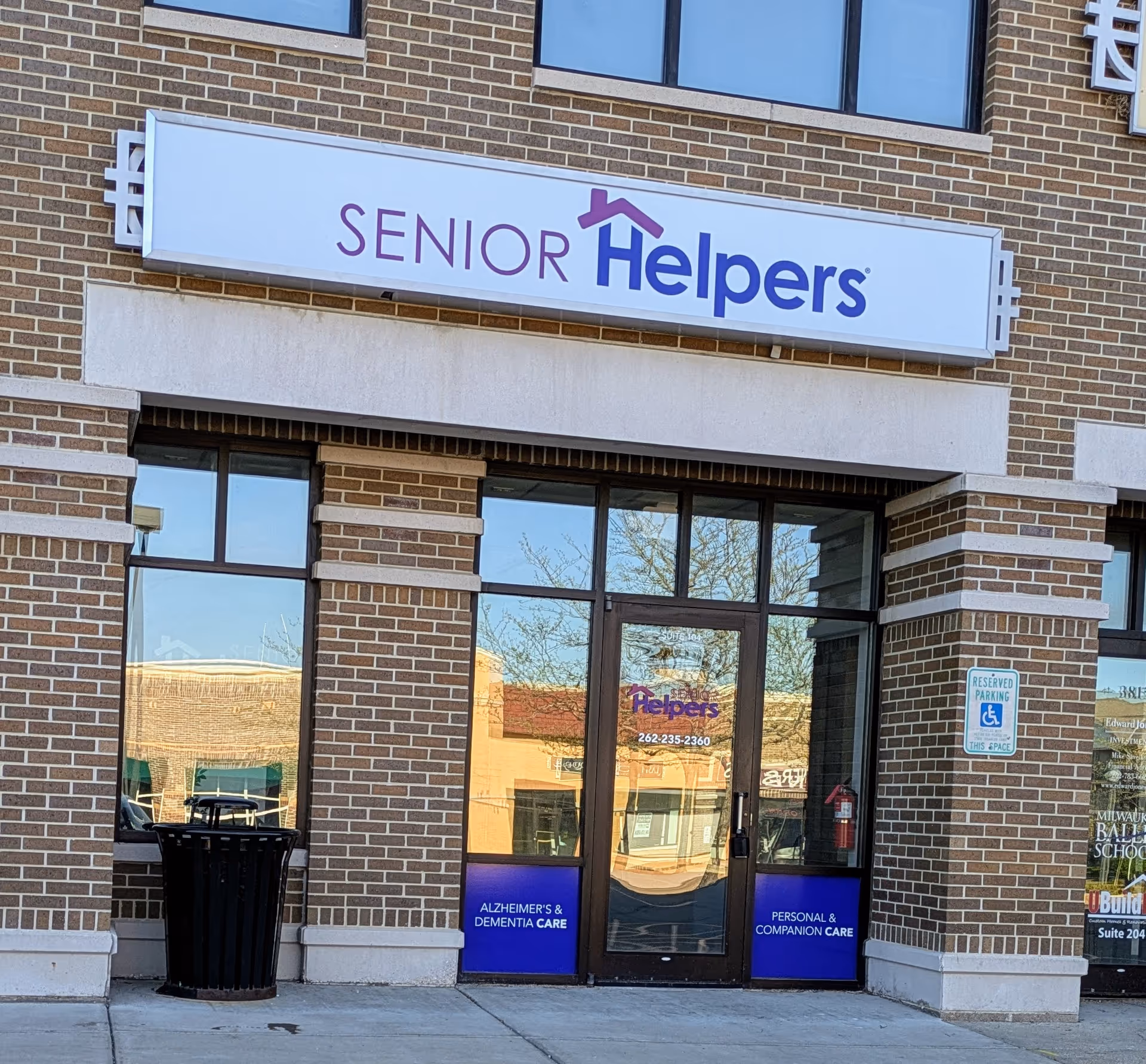 Brick building with a large Senior Helpers sign above glass entrance doors.