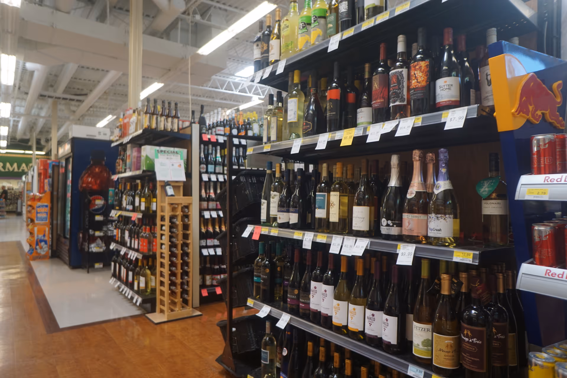 Aisle of wine bottles on shelves inside Discount Drug Mart.