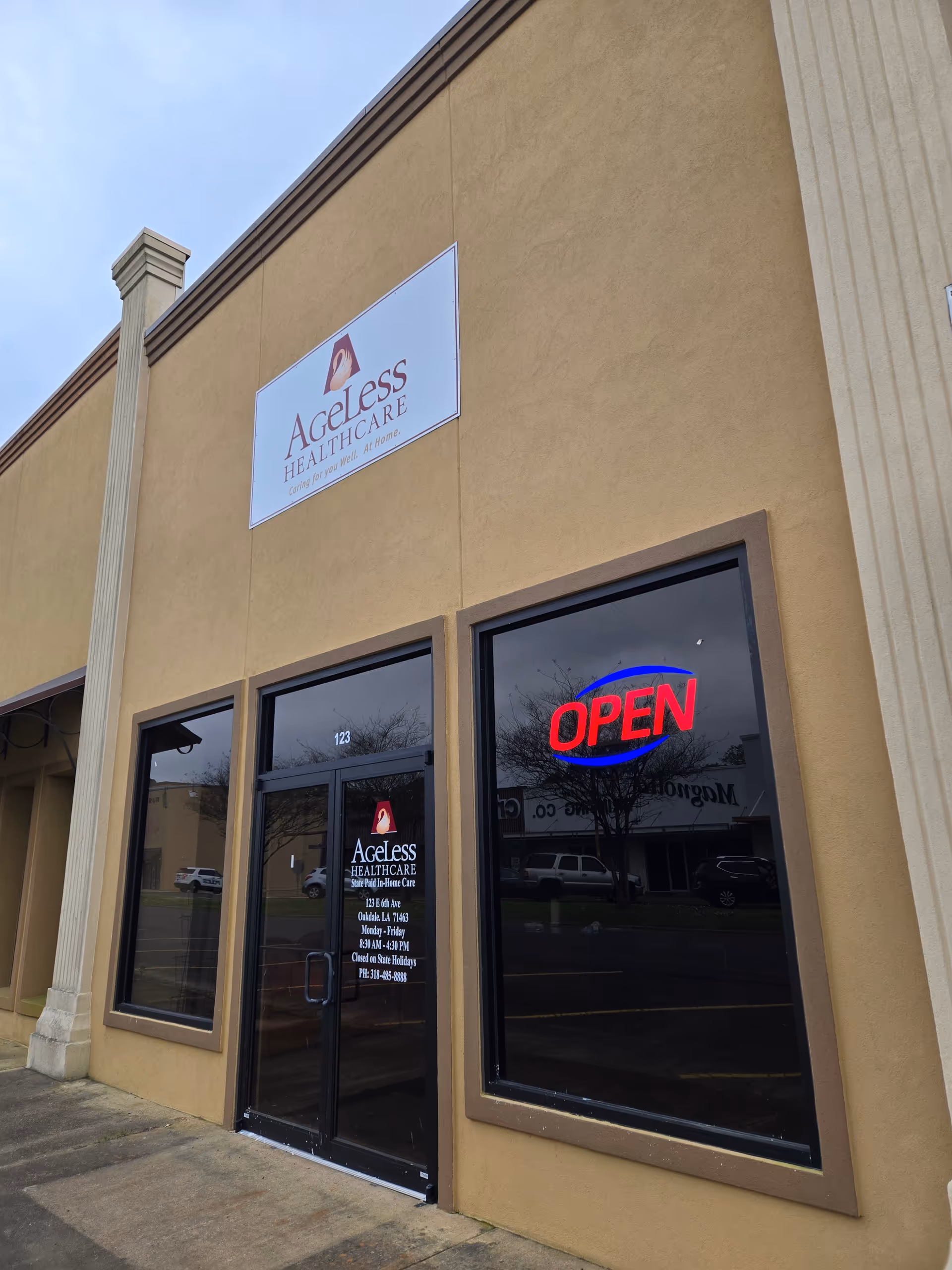 Exterior view of Ageless Healthcare building with an OPEN sign.