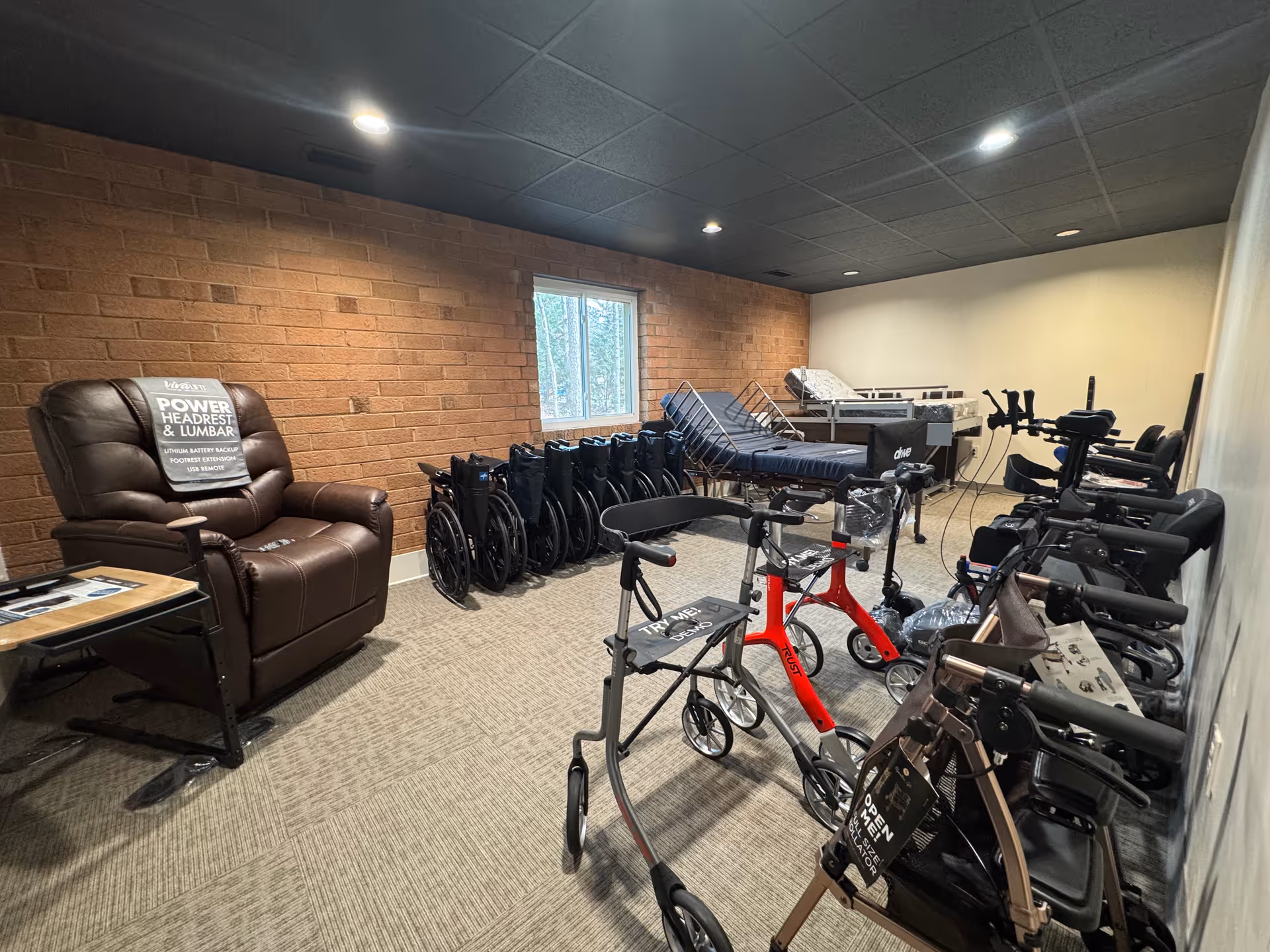 Well-lit interior fitness room with exercise bikes, wheelchairs, and a recliner.