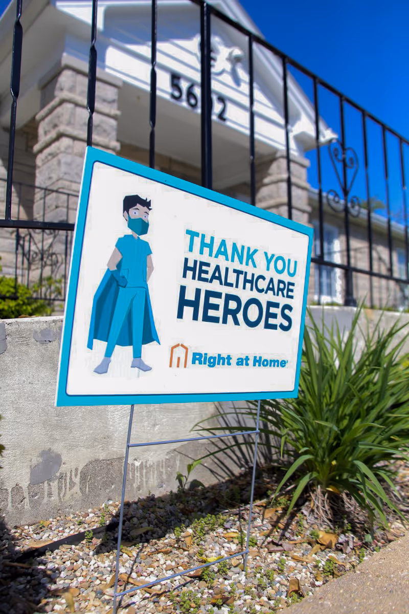 Exterior view of Right at Home facility with a 'Thank you healthcare heroes' sign.
