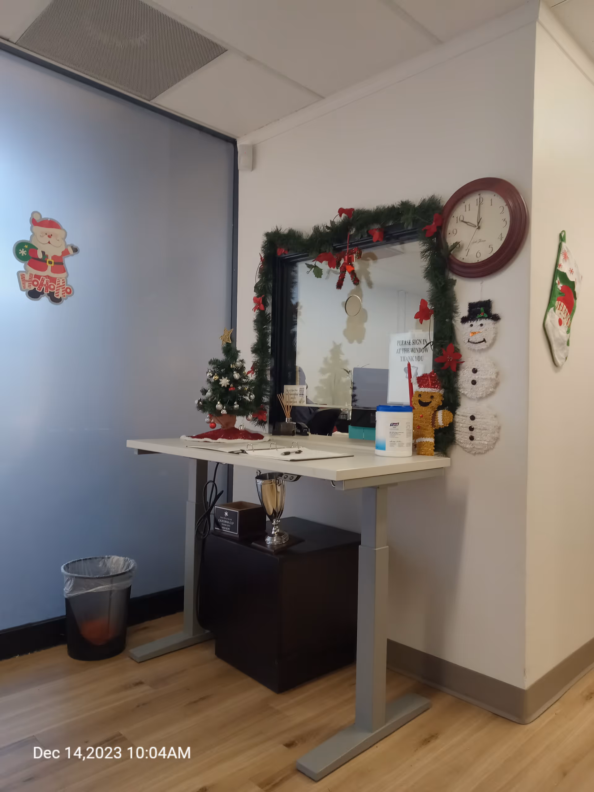 Reception desk with holiday garland and decorations inside a senior living facility.