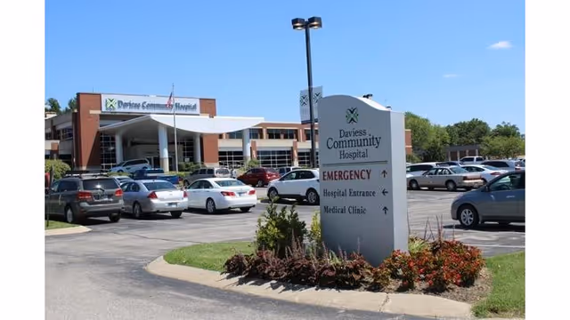 Front view of Daviess Community Hospital with parked cars and entrance