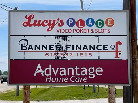Outdoor signboard advertising Lucy's Place, Banner Finance, and Advantage Home Care.