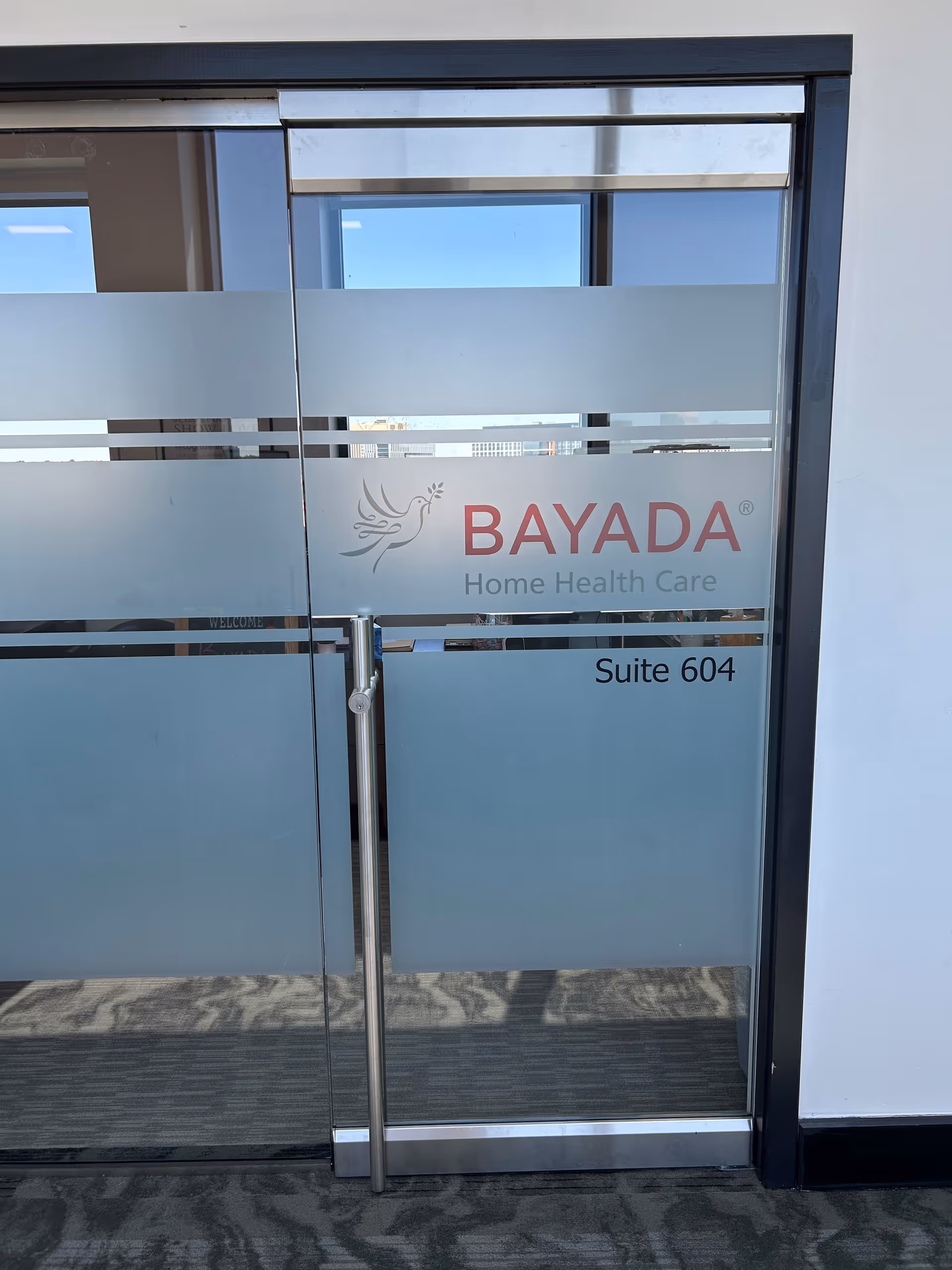 Glass entry door displaying BAYADA Home Health Care and Suite 604