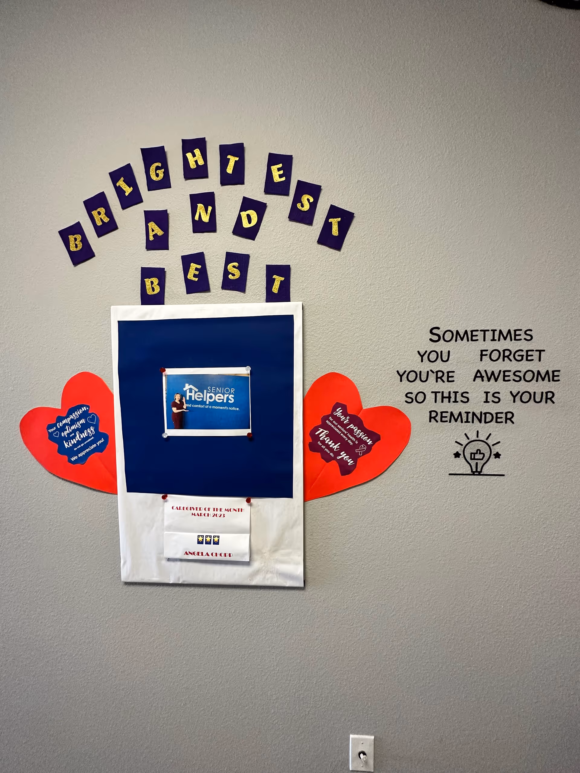Interior wall decor featuring a Senior Helpers display, red hearts, and an inspirational quote.