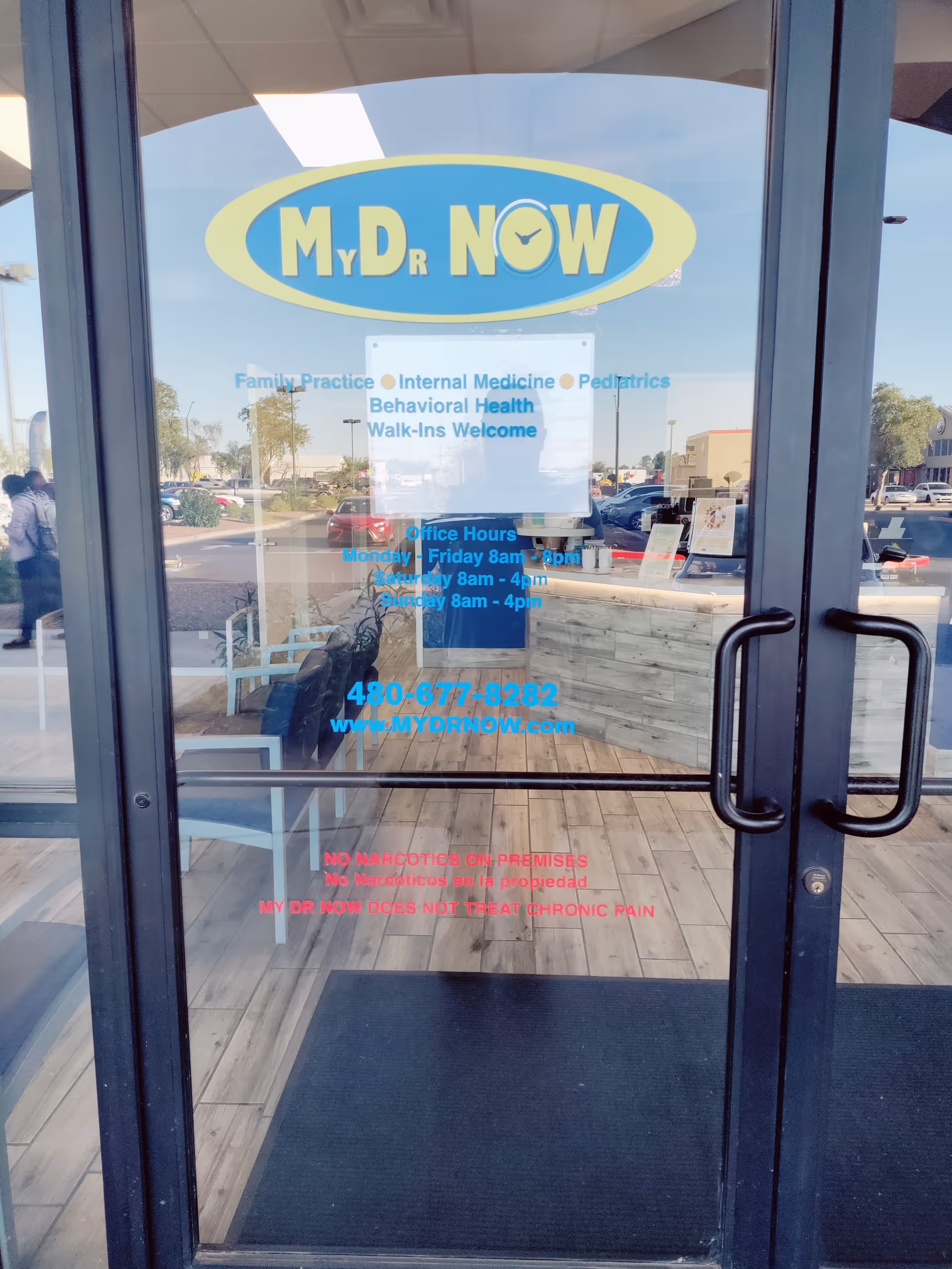 Glass entrance door shows MY DR NOW logo with blue service text and reflections.
