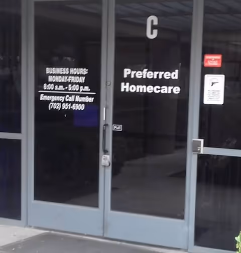 Glass storefront entrance showing Preferred Homecare signage, hours, and emergency contact number.