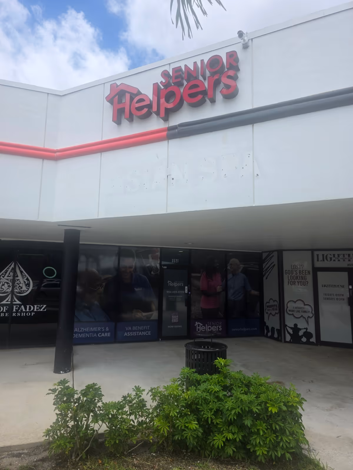 Exterior view of Senior Helpers storefront with large sign and glass entrance doors.