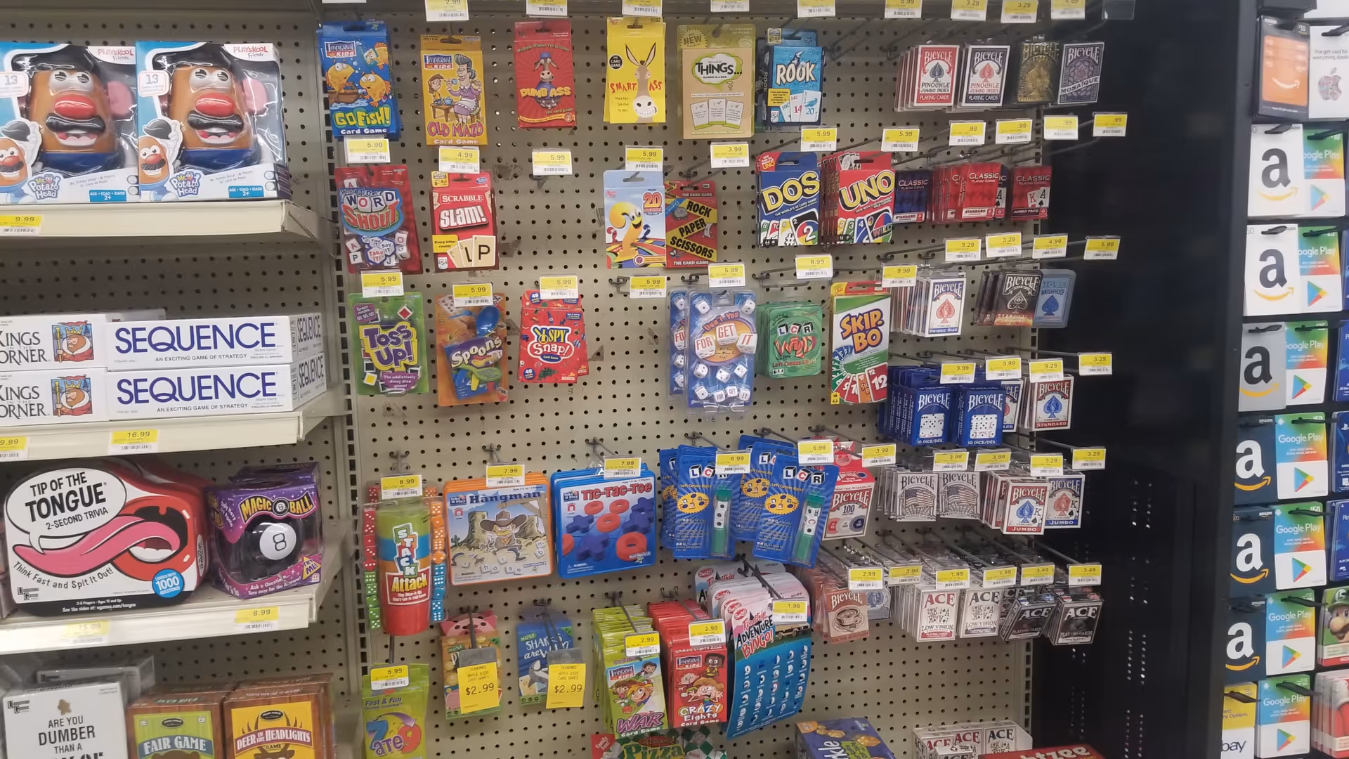 Store shelves at Discount Drug Mart display assorted games and novelty items.