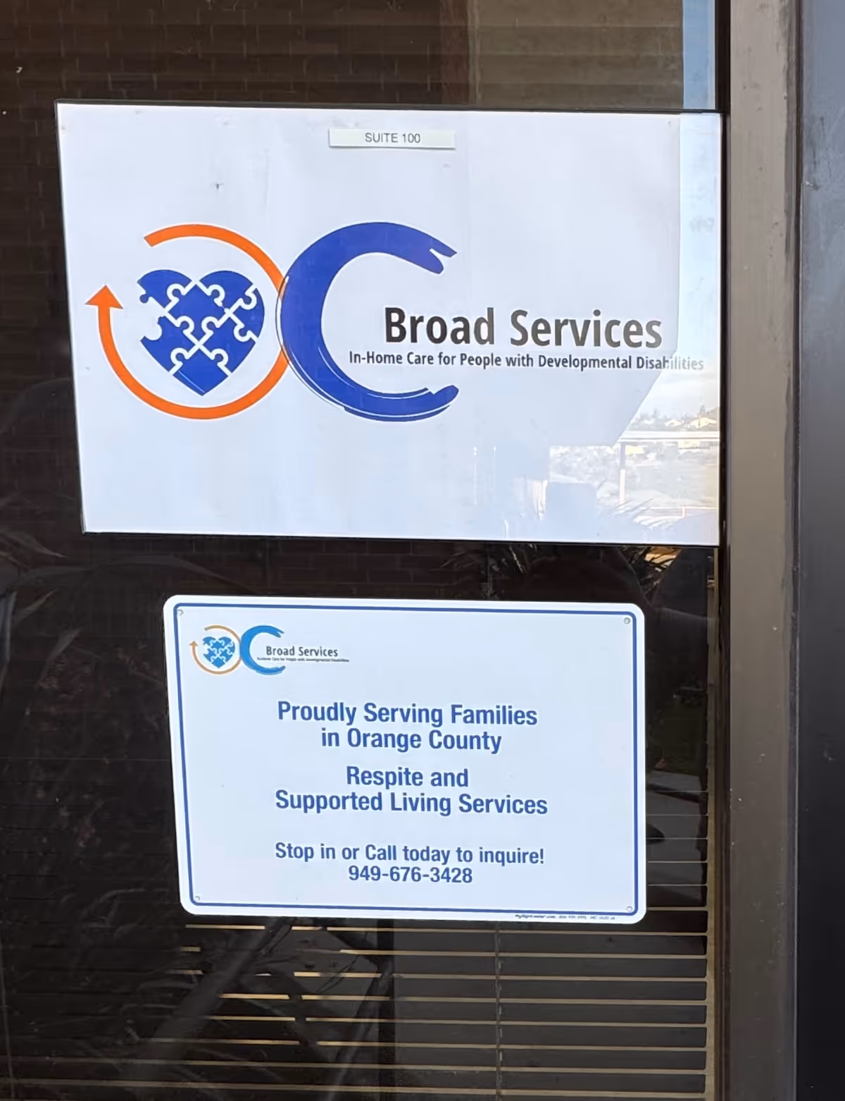 Exterior door sign for Broad Services with logo and in-home care information, Orange County.