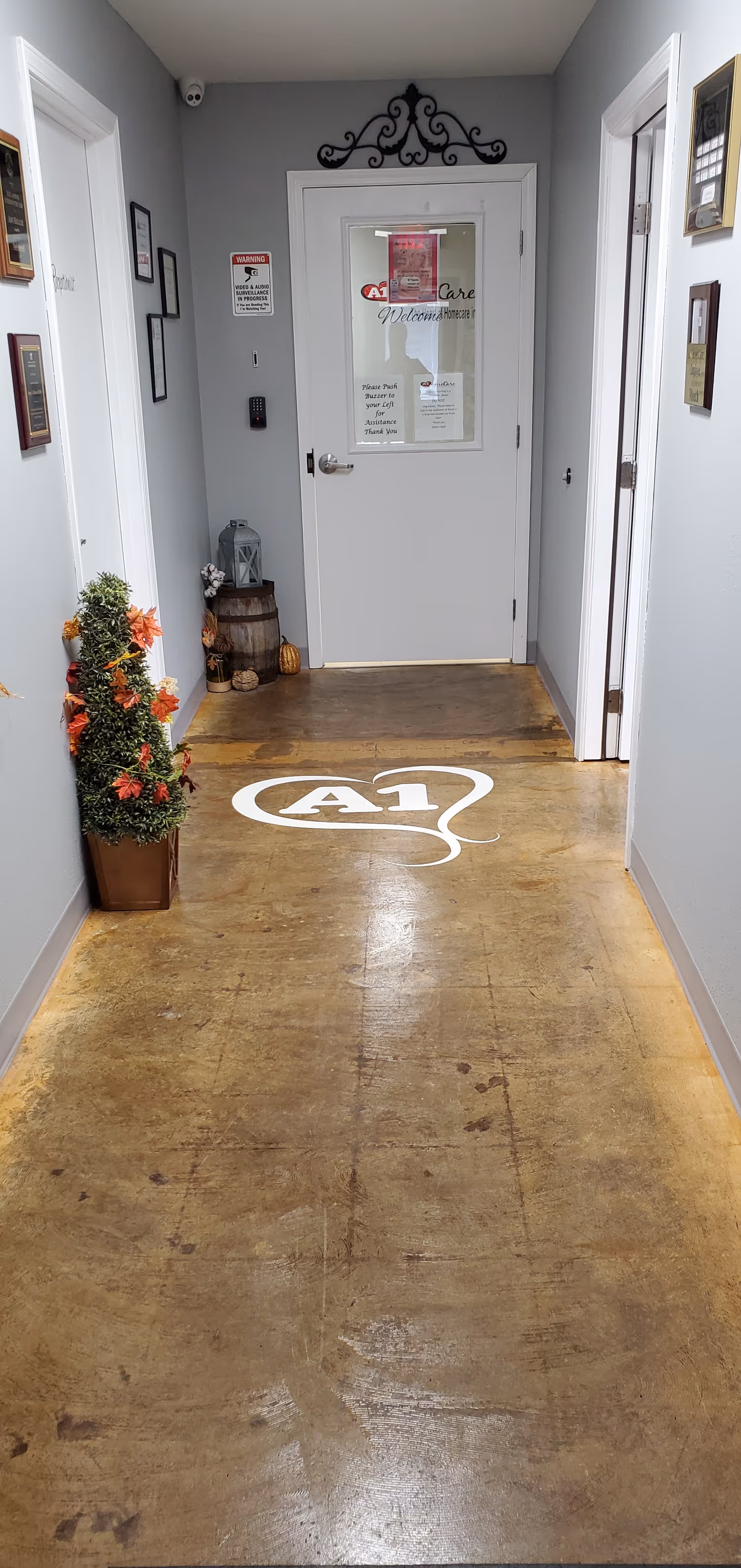 Hallway inside a senior care facility with A1 logo on the floor and wall décor.