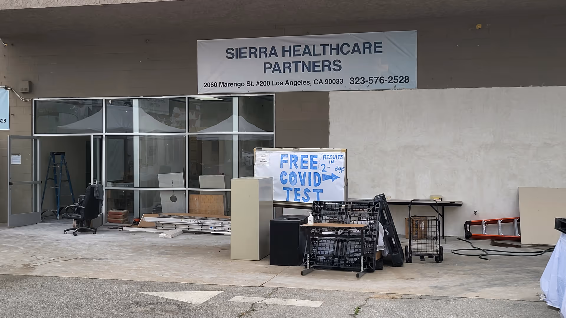 Sierra Healthcare Partners building front with glass entry, equipment, and a free COVID test sign.